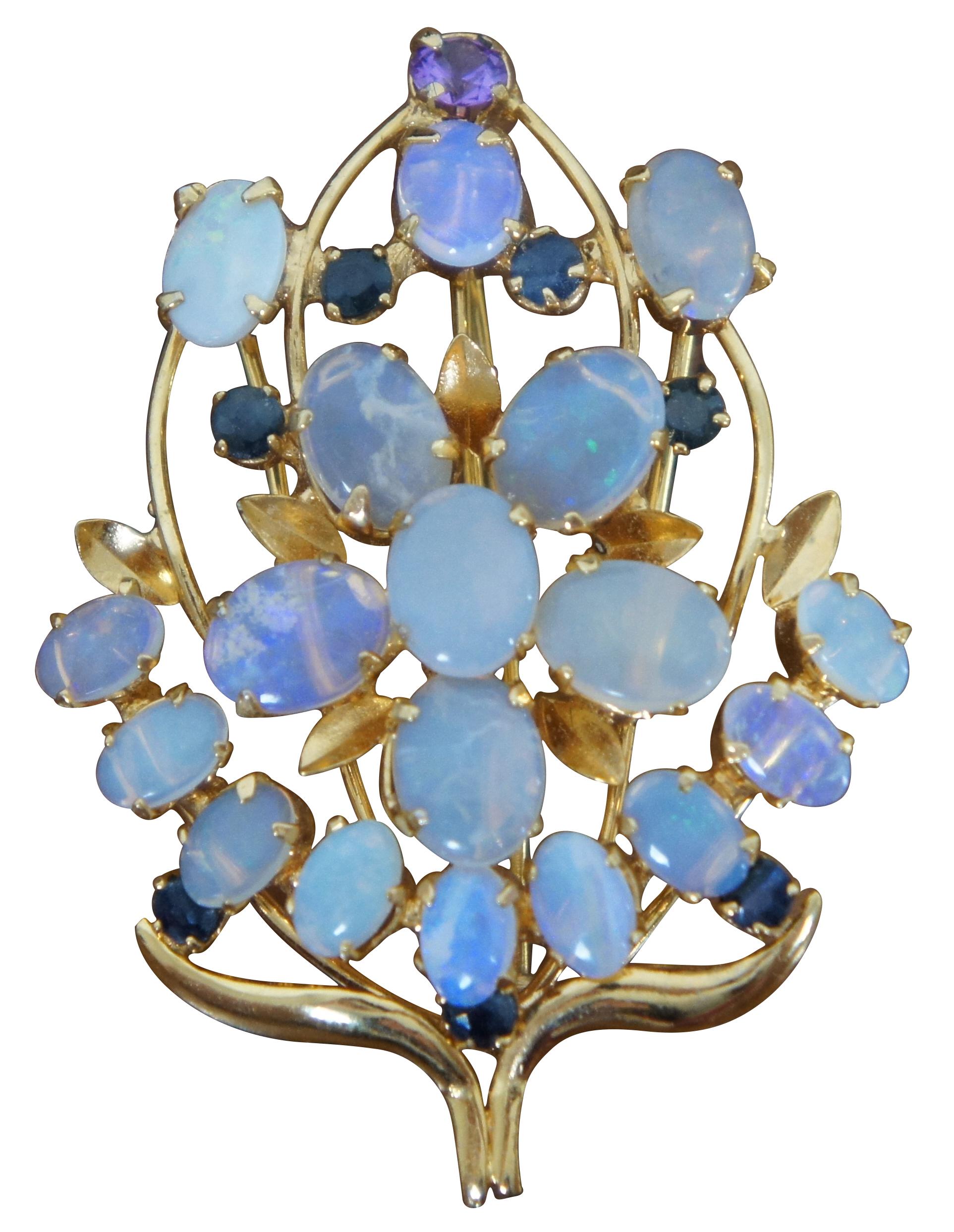 Pair of pins / brooches / pendants circa mid-20th century, featuring opals and sapphires in the shape of a flower bouquet.