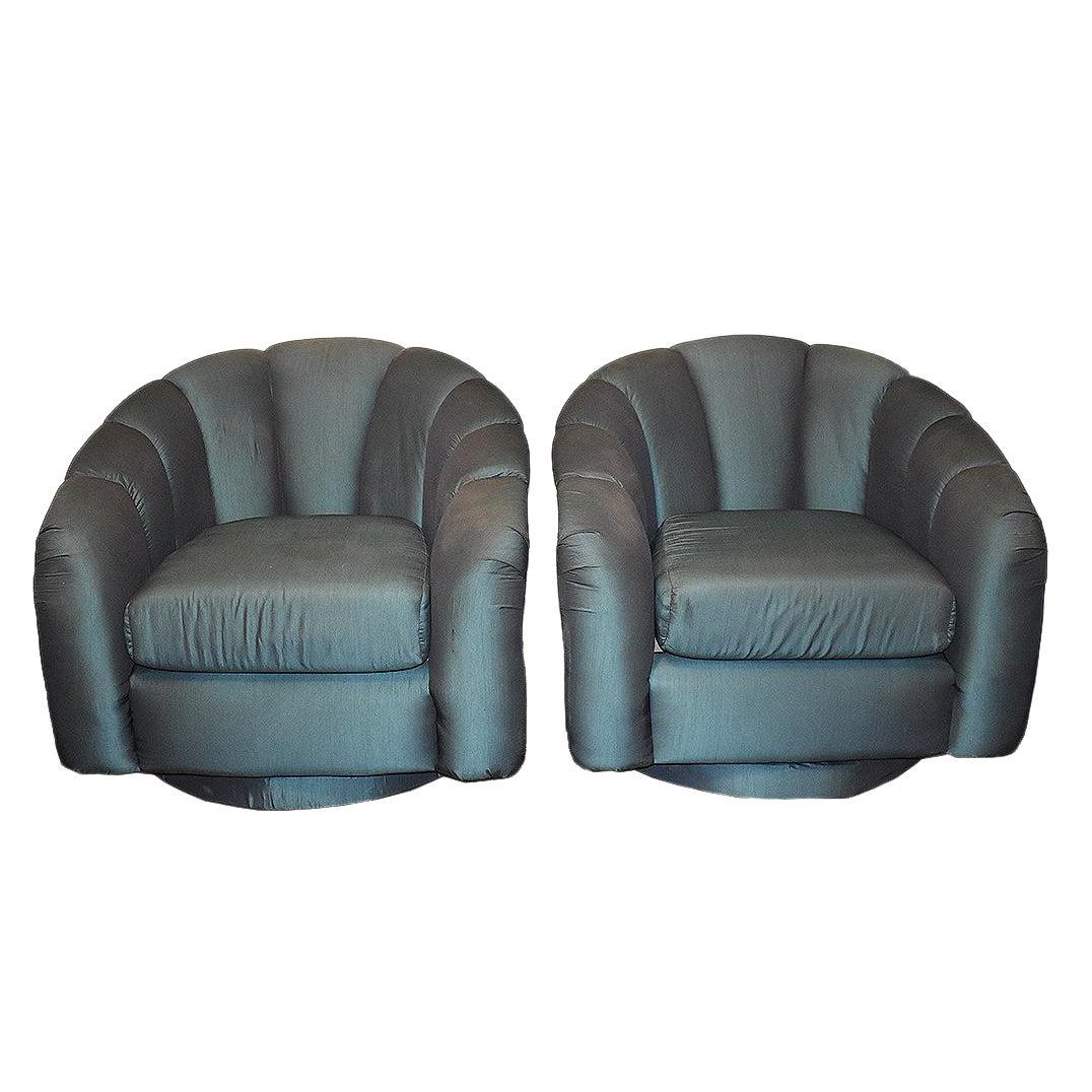 Pair of Mid-Century Modern shell shape back swivel armchairs in the style of Milo Baughman for Thayer Coggin. These beautiful armchairs both rest on a covered matching upholstered plinth base and swivel 360 degrees. The backs showcase striking