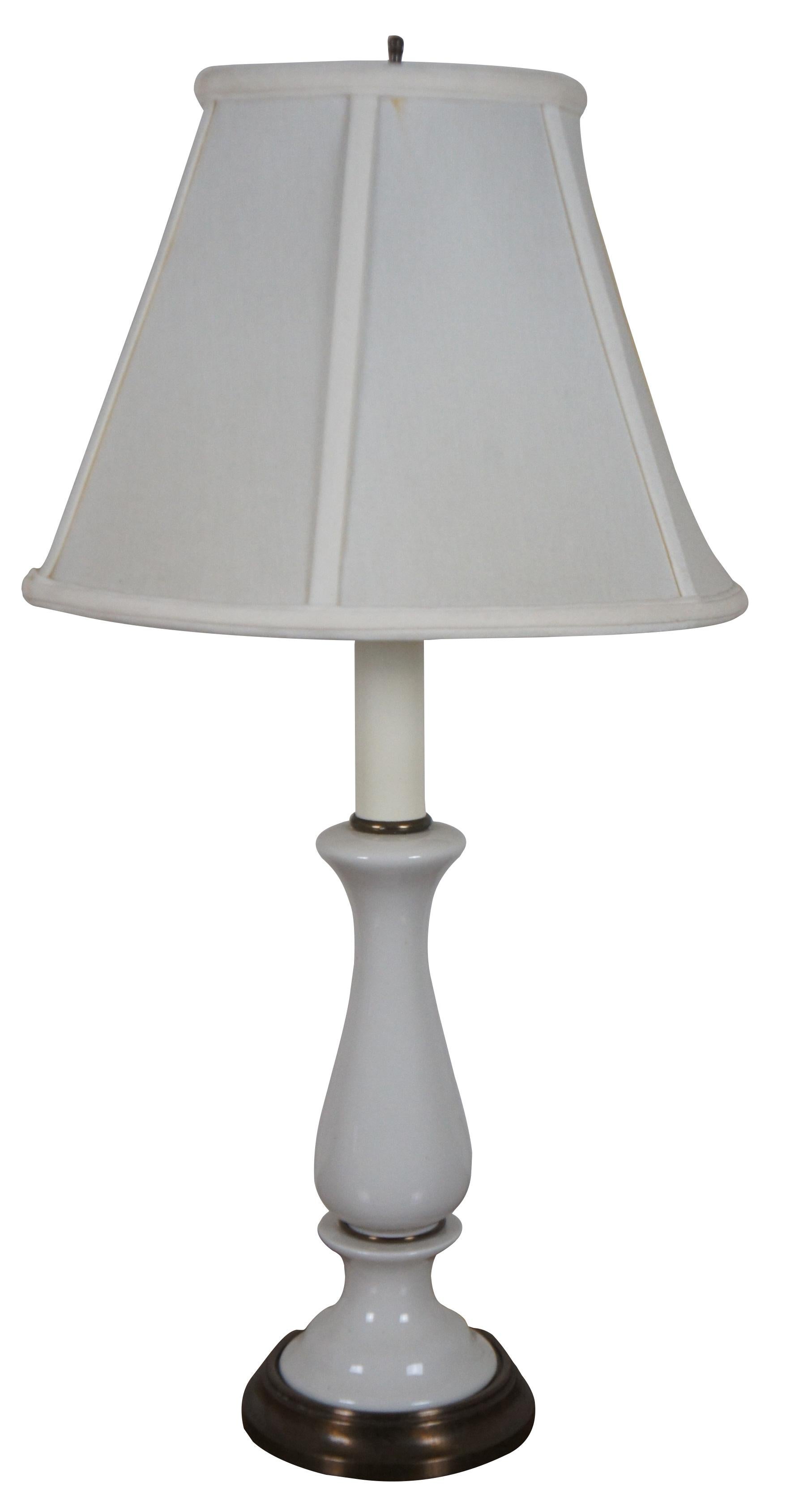 Pair of mid century Kichler white porcelain Boudoir size table lamps with candlestick tops and white shades.

Measures: 5.25” x 24” / Shade - 12.25” x 8.5” (Diameter x Height).