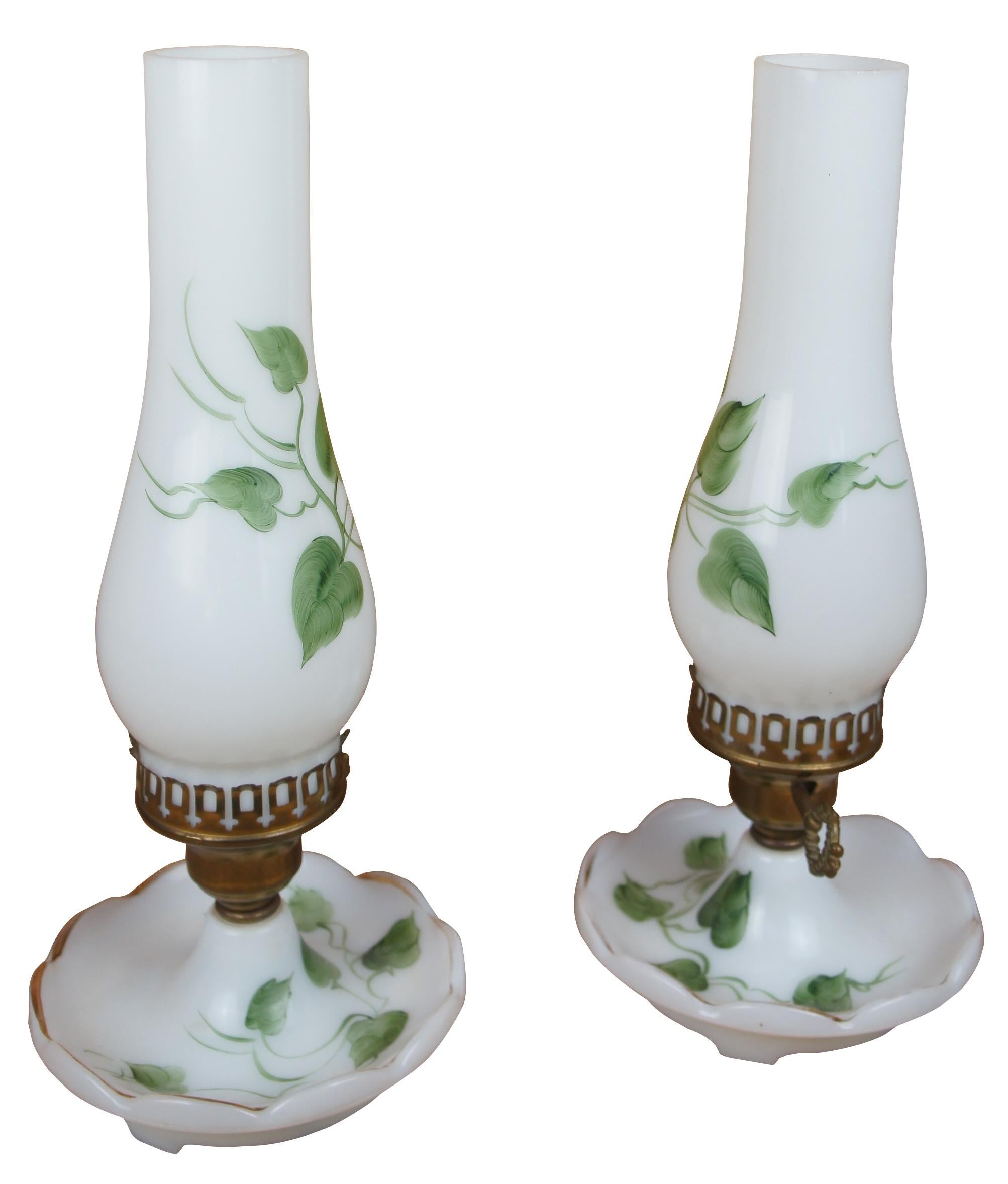 Two vintage mid century hand painted brass and white milk glass desk / library / vanity lamps featuring chamber candlestick style base and hurricane shades with green ivy and vines. Measure: 13