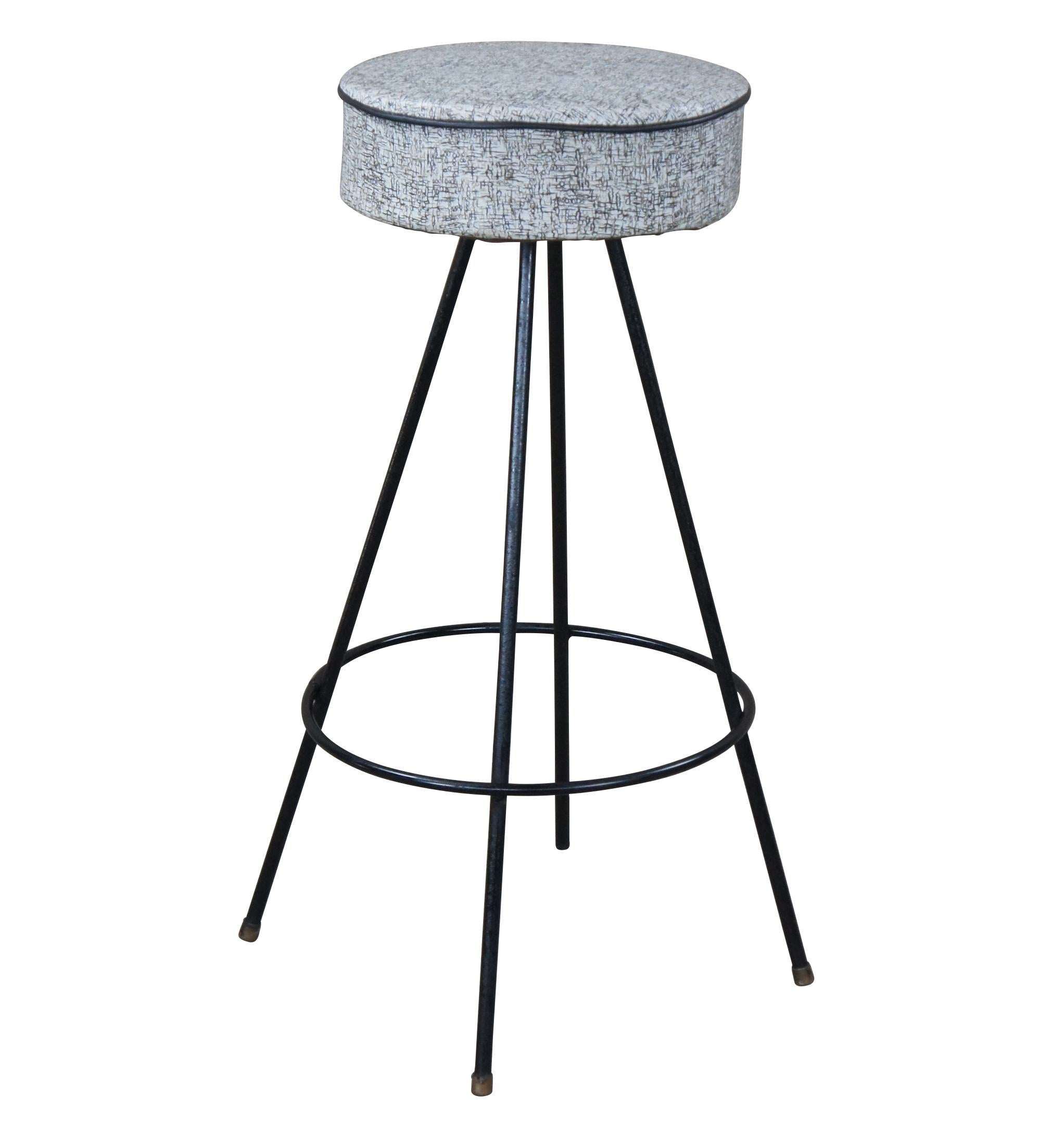 Atomic era bar stools. Made from wrought iron with a vinyl seat. Features a round seat over 4 legs leading to foot rest and capped feet.

Seat Diameter - 12