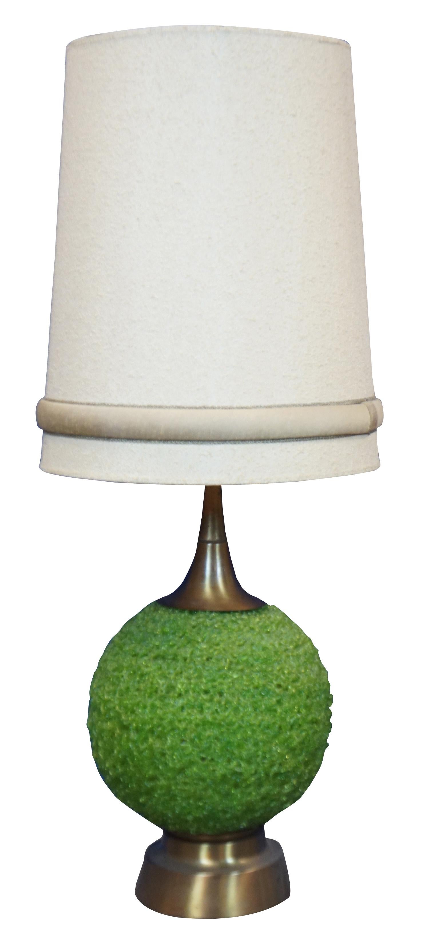 Two large Mid-Century Modern / atomic age table lamp featuring orbs of spun green lucite on brass bases. Includes trimmed linen shades.

Measures: 13” x 28” / Shade - 18.5” x 22” (Diameter x Height).