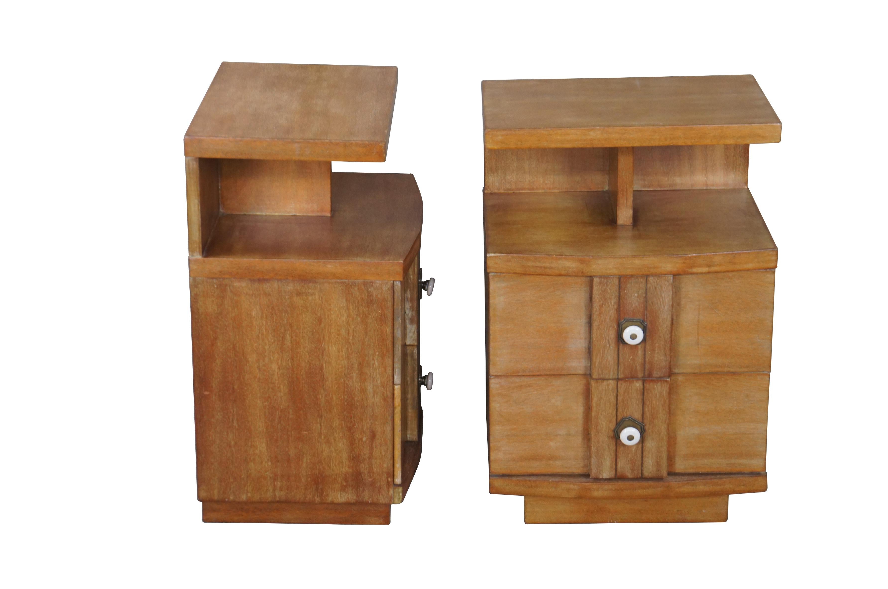 Pair of Kent Coffey end tables, circa second half 20th century.  Made from oak with two dovetailed drawers and a lower divided cubby shelf.  The Titan line was manufactured in the 1970s.  

The Kent-Coffey Manufacturing Company was started in 1907