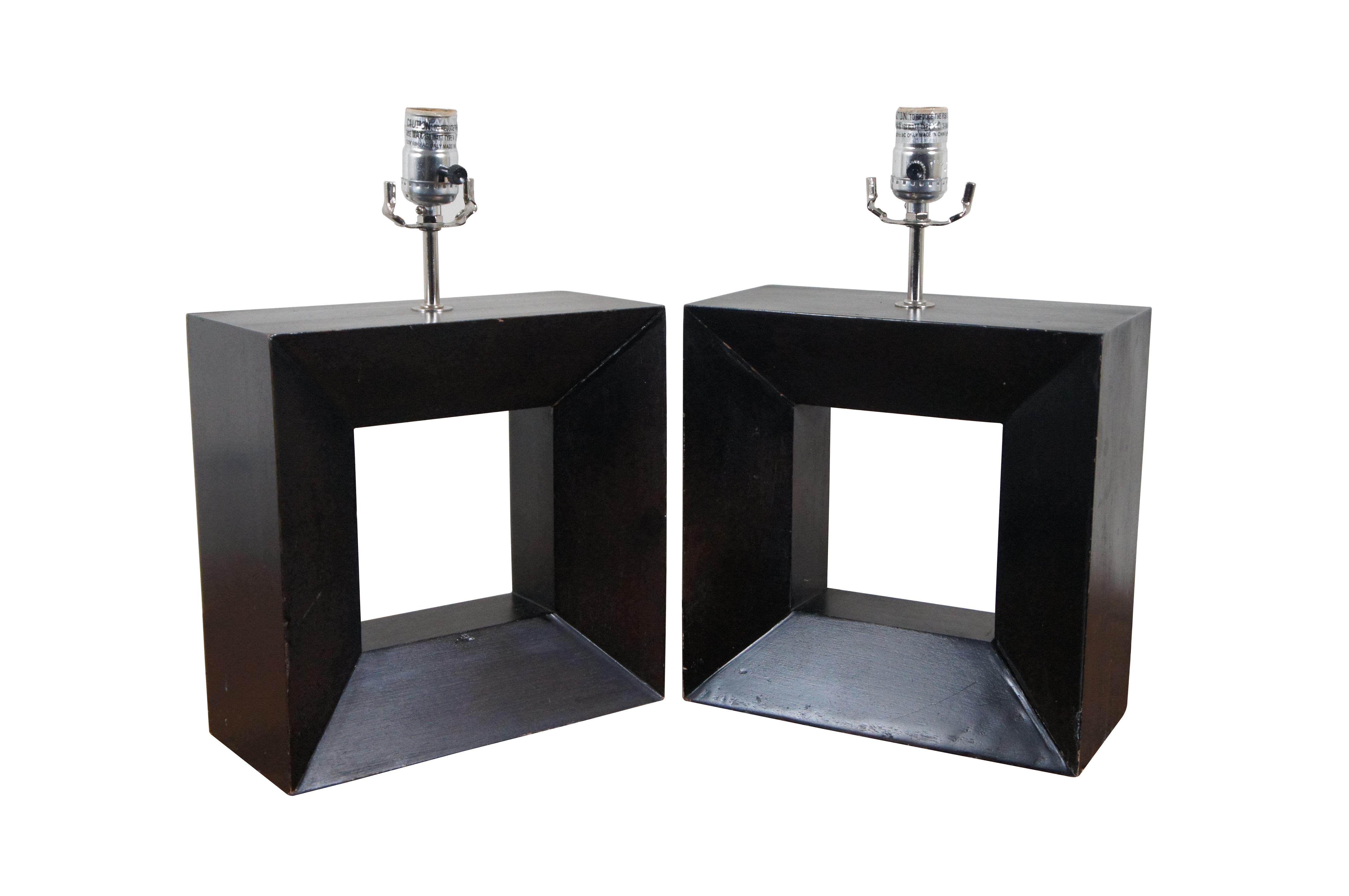 Pair of mid century modern wooden table lamps featuring square beveled forms with cut out centers, with a deep, ebonized finish. No harps.

Dimensions:
10.75