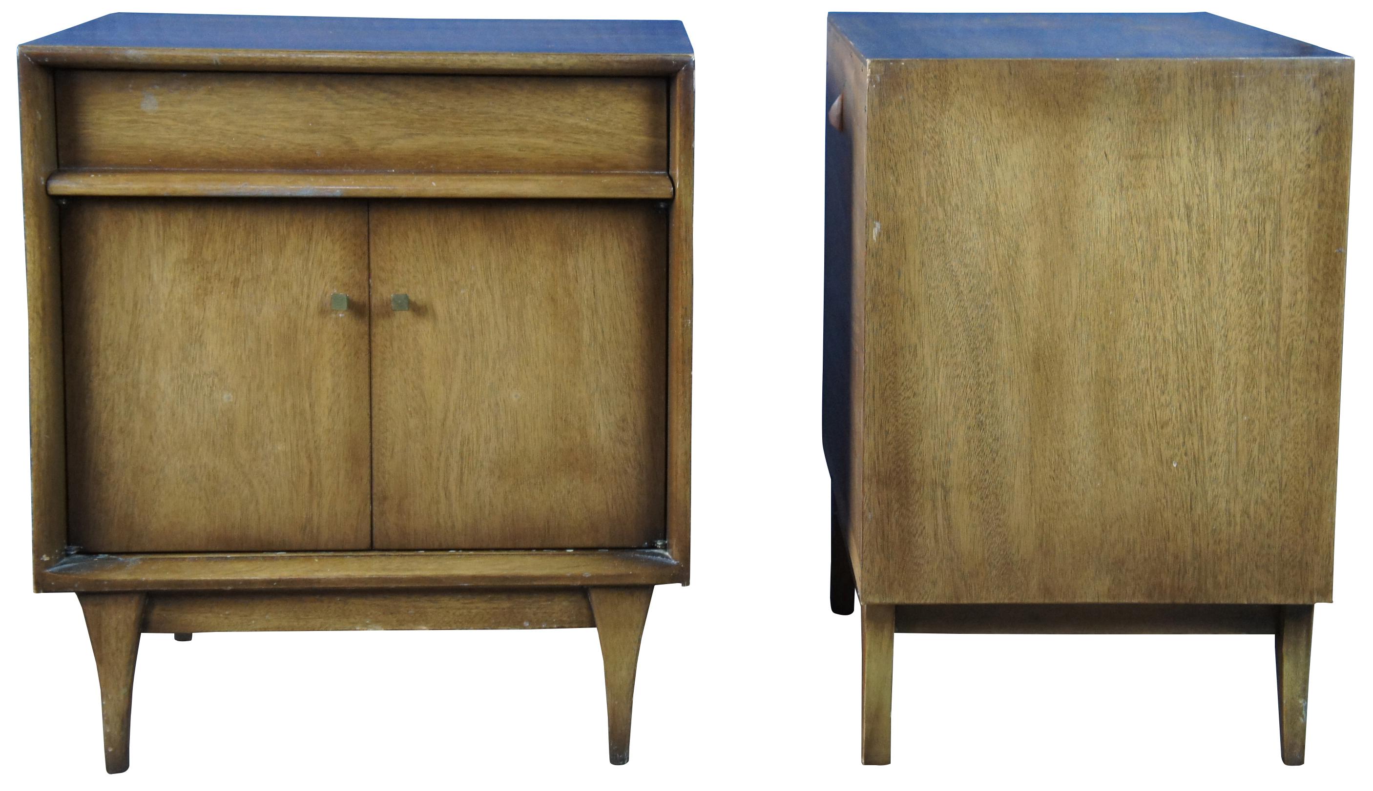Two Mid-Century Modern side table nightstands. Made of walnut featuring cube form with one drawer and cabinet over tapered legs.
 