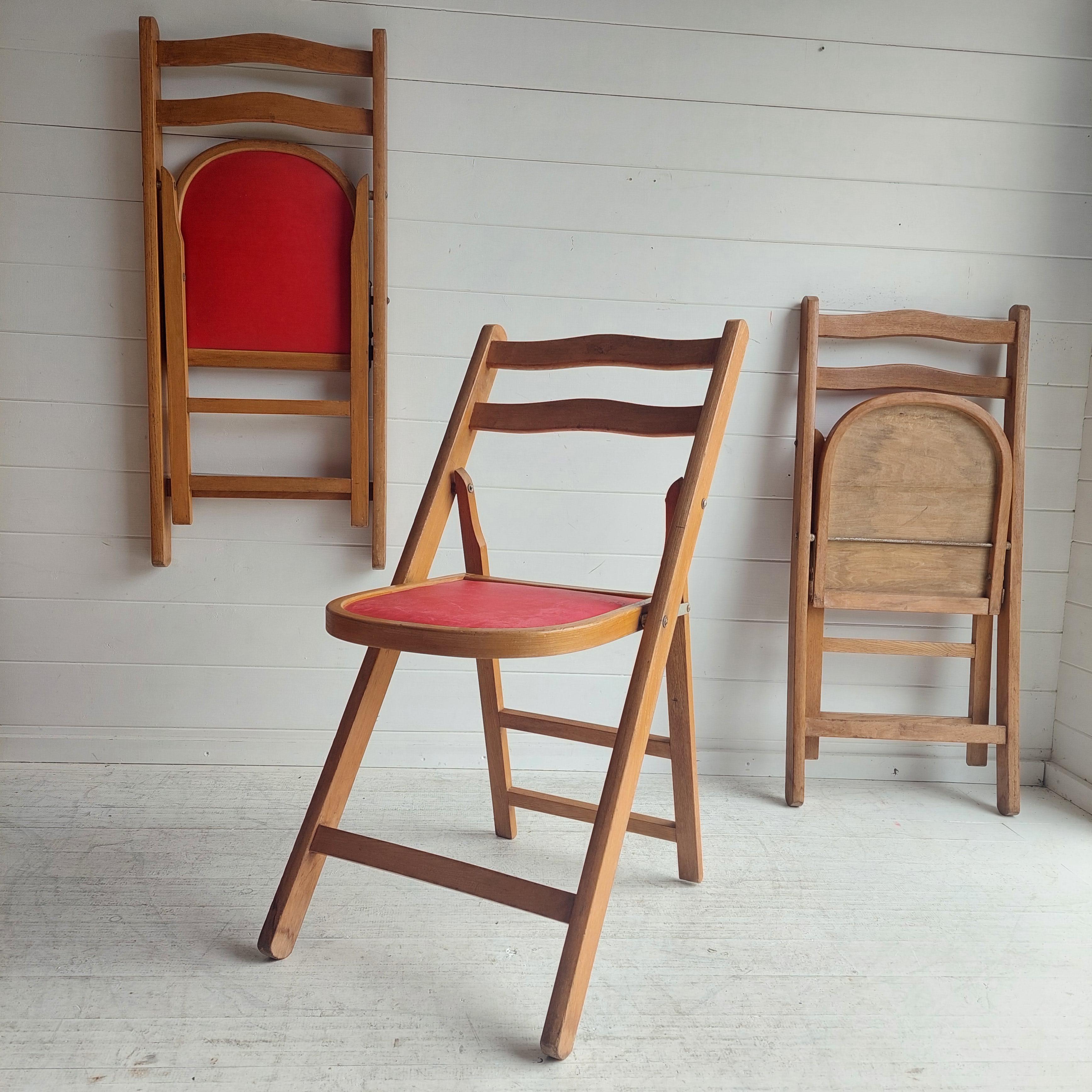 Set of 3 folding chairs produced most probably in Sweden in the 1950s 60s. 
Beechwood frame, seat in red cotton fabric. 
These wooden folding chairs are a great vintage find. 
The chairs are full of retro character.

Their folding ability makes them