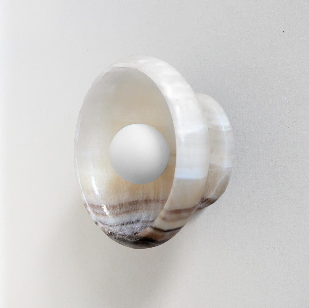 (2) Milk Onyx Sconces
(2) Black + White Onyx Sconces

Our Piedra lighting takes its inspiration from the stone masks of the ancient civilization of Teotihuacán. Carved in the Mexican city of Tecali — which means ‘stone house’ in Nahuatl — the