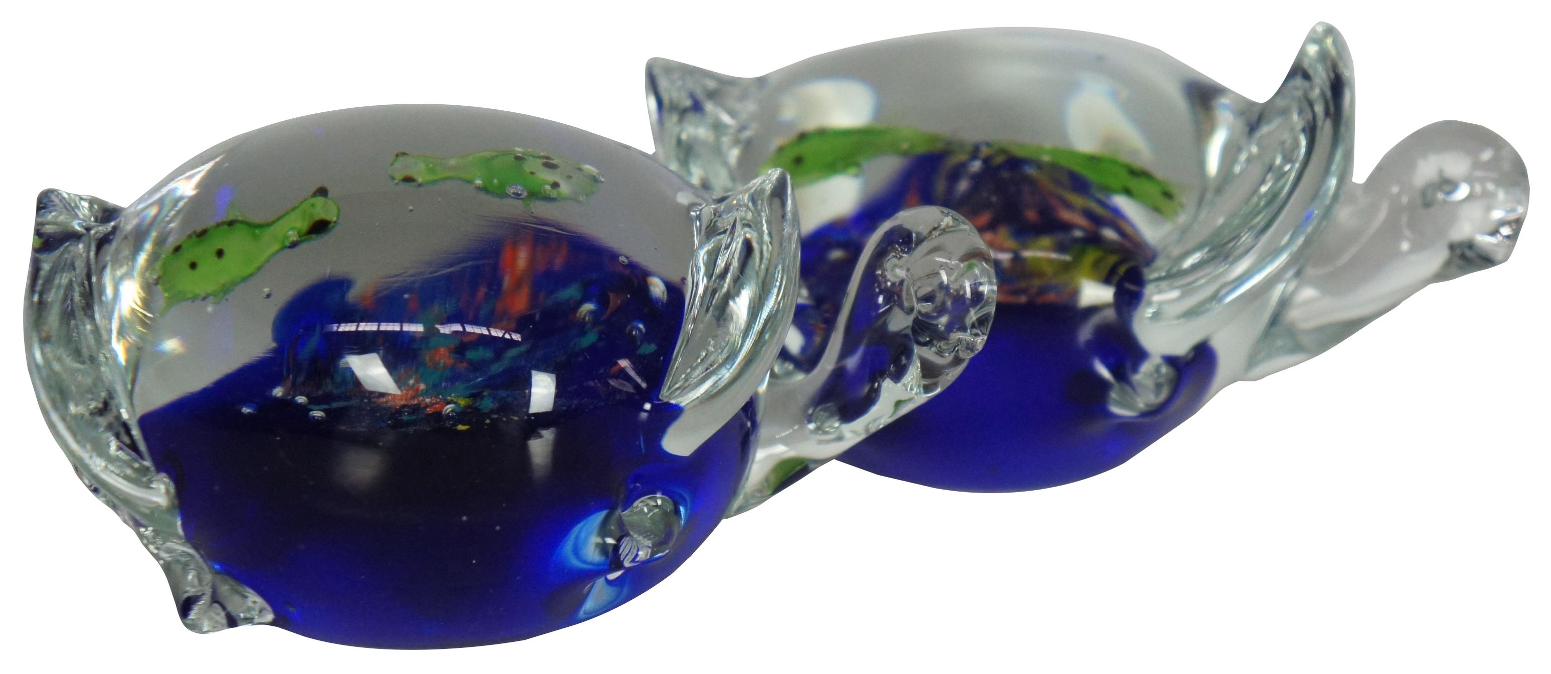 Pair of hand blown Italian art glass figurines / paperweights or hand chillers in the shape of sea turtles with a miniature aquarium scene of two more turtles inside their shells. Measure: 5