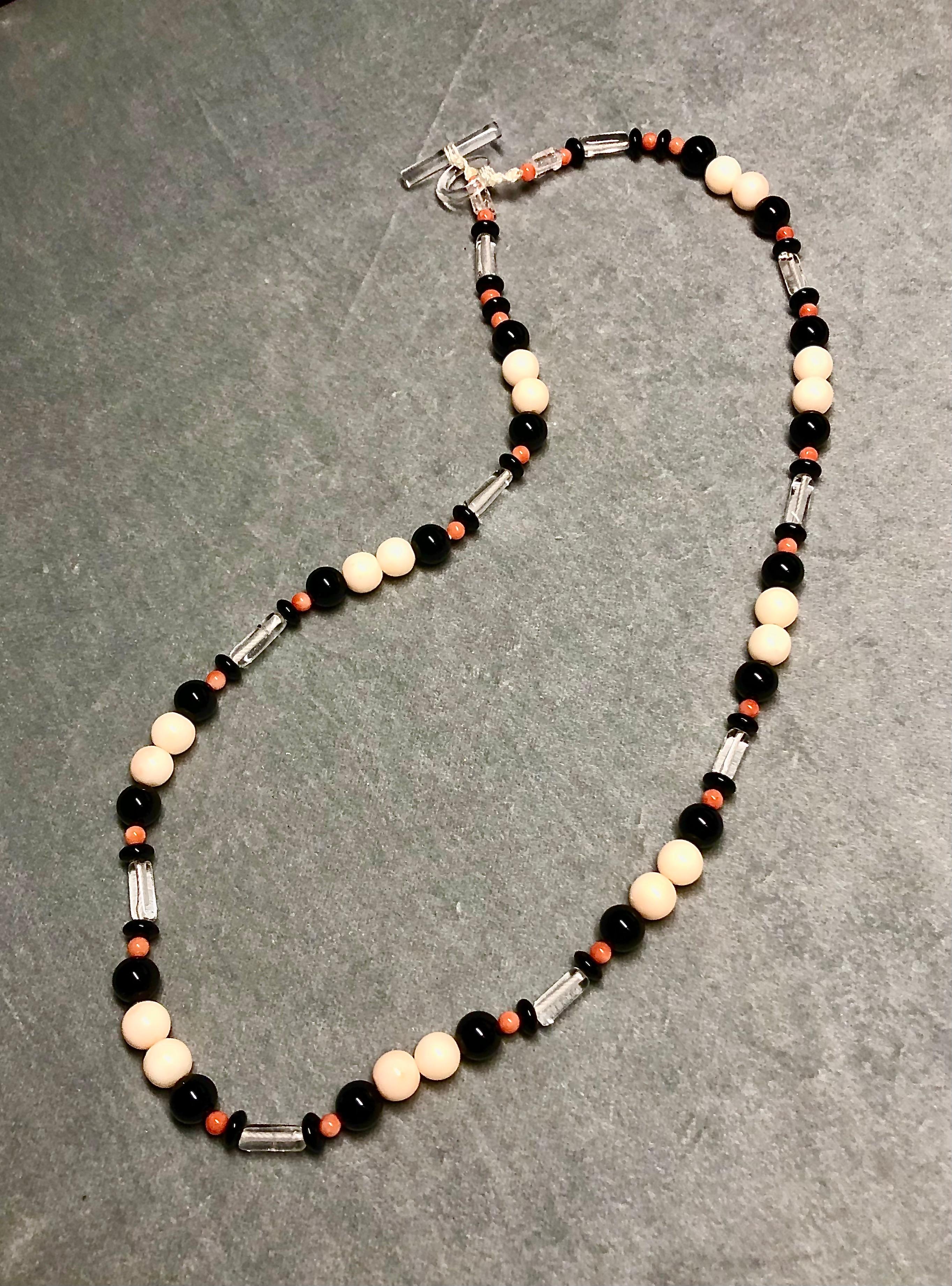 Double strand necklace. Two necklaces, one a single strand with coordinating pattern designed to be worn inside sautoir are separately as desired. Sautoir with red/orange coral beads, black onyx beads, rock crystal tubes and blackened silver