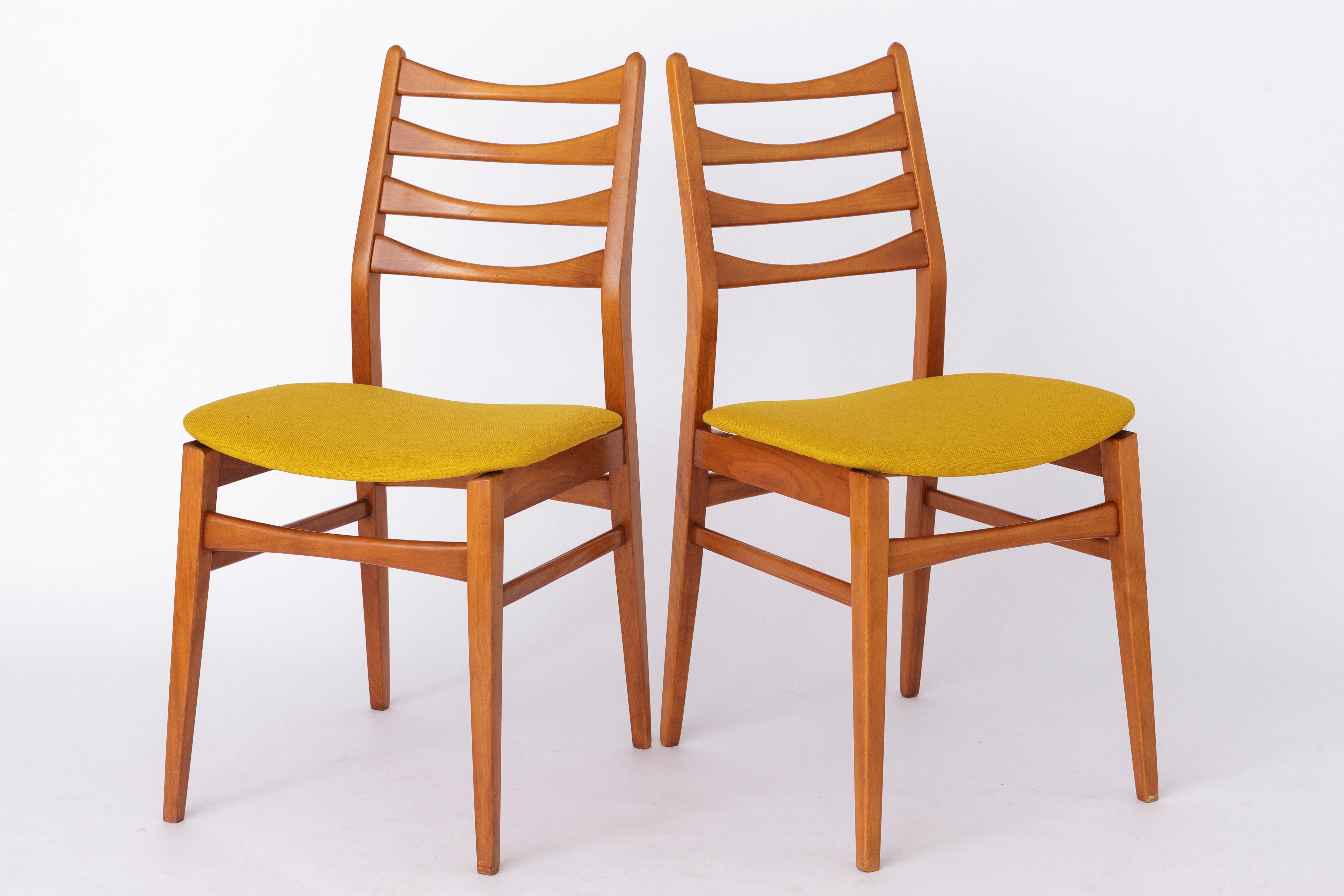 Pair of German vintage chairs. Production period approx. 1960s-1970s. 
Unknown manufacturer. 
Displayed price is for a pair. Totally up to 4 chairs (2 pairs) available. 

Sturdy beech wood frame. Refurbished and oiled. 
Reupholstered with yellow