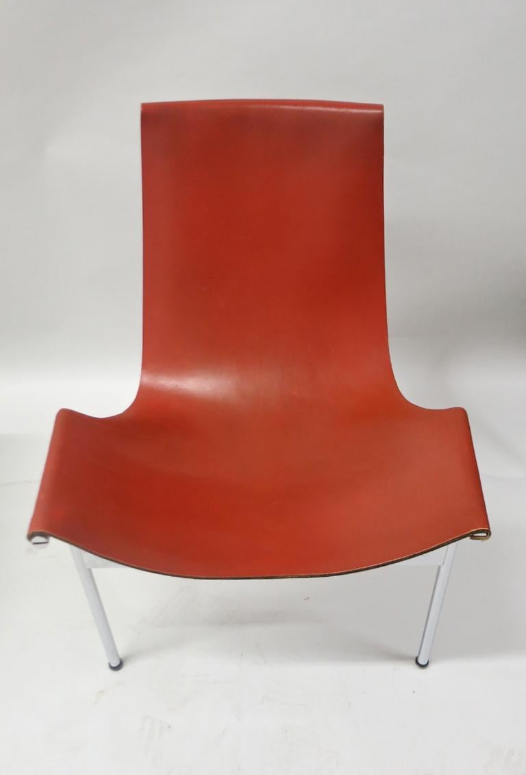 Two well maintained, vintage T-chairs designed by Ross Littell, William Katavolos, and Douglas Kelley for Laverne International both with an all-chromed base and red-brown saddle leather with special ordered leather backing in a matching tone. Both