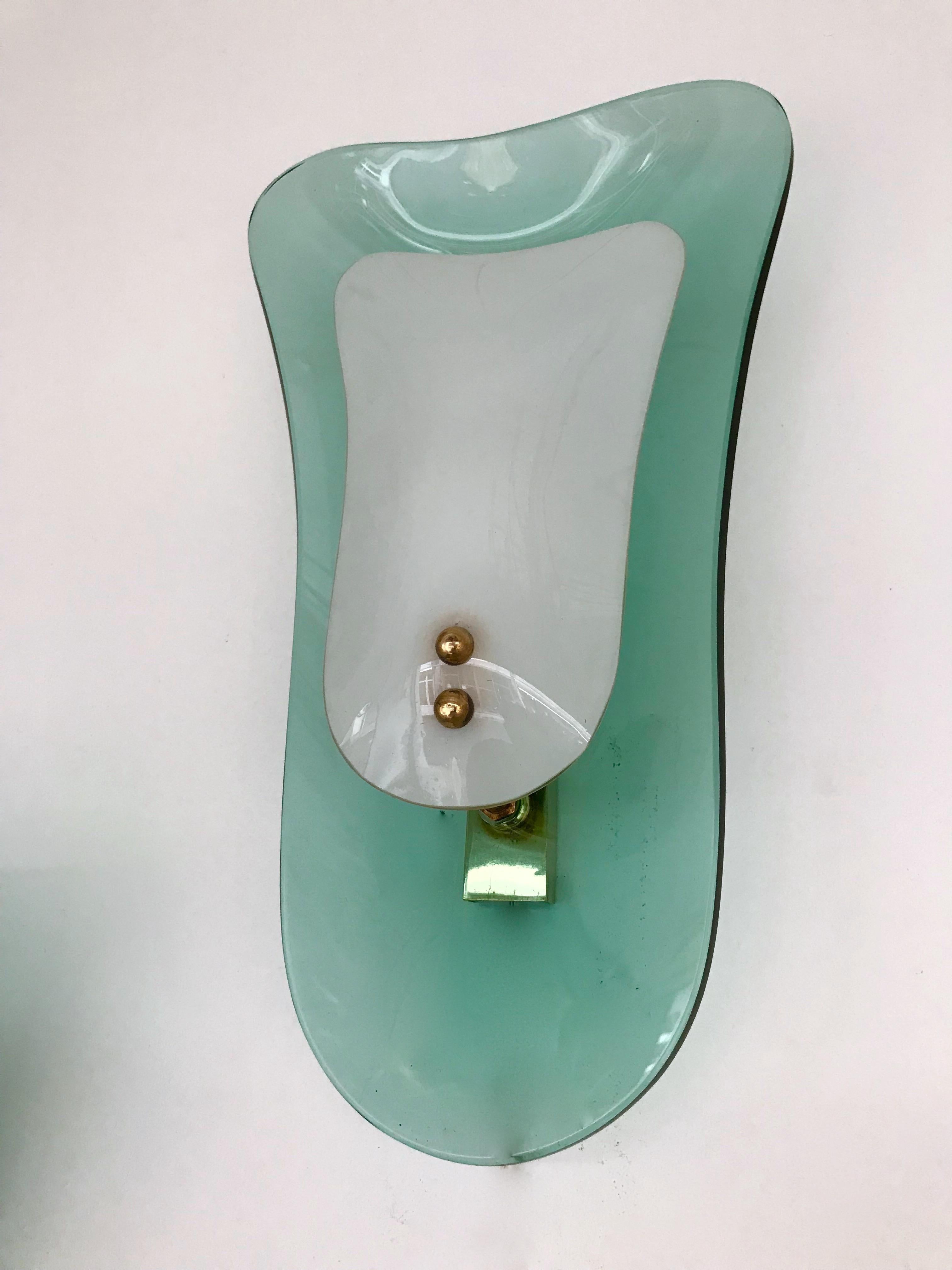 Rare wall lights sconces in blue turquoise green curve glass and opaline diffuser, brass elements by the famous glass manufacture Cristal Art who was the concurrent of Fontana Arte at the same period. The sconces are referenced in the Cristal Art