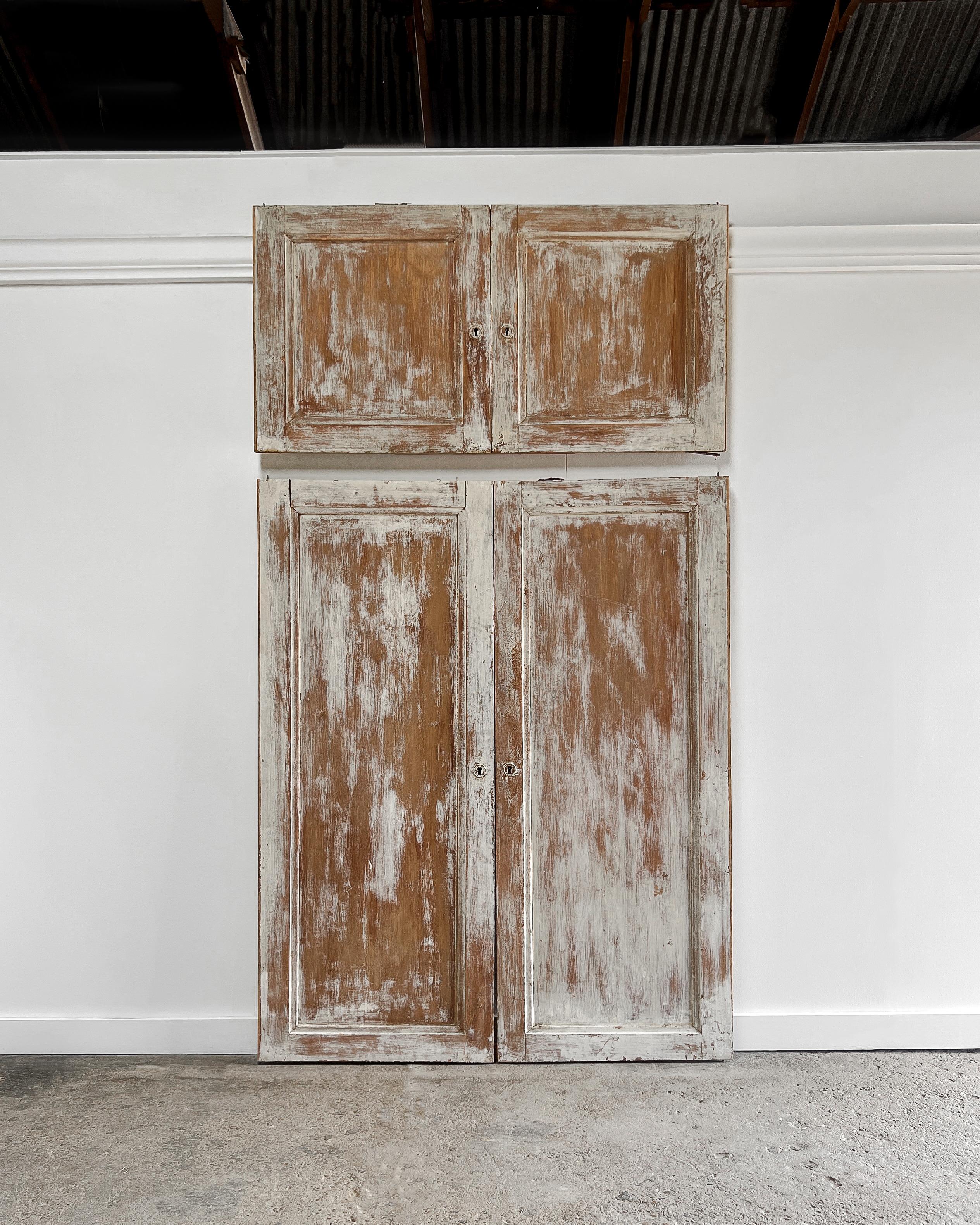 Revamp a modern built-in cabinet using this set of two pairs of reclaimed flat-panel cupboard doors. These doors boast beveled trim details and a charmingly worn patinated finish, bringing character and authenticity to your space—a refreshing