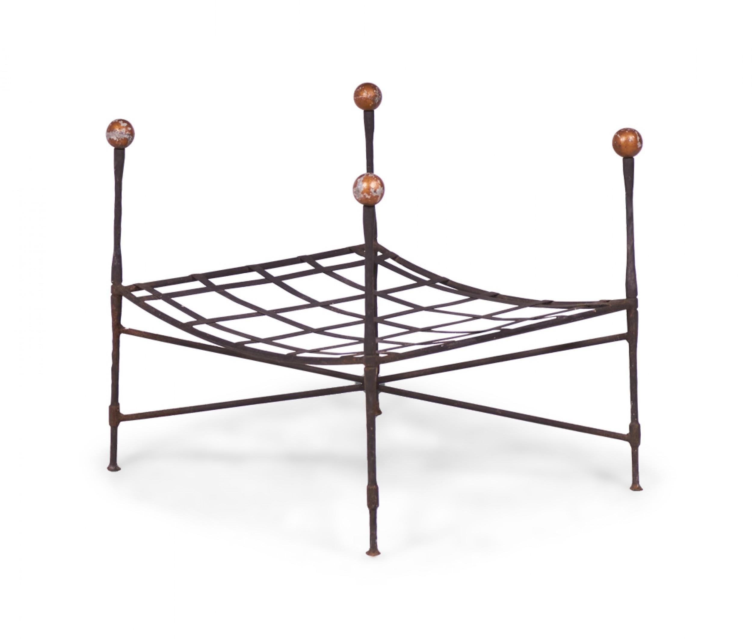2 Pairs of American mid-century iron outdoor ottomans with a curved lattice structure supported by four posts topped with gilt ball finials and an x-base (missing cushions). (JOHN SALTERINI)(PRICED PER PAIR)
 