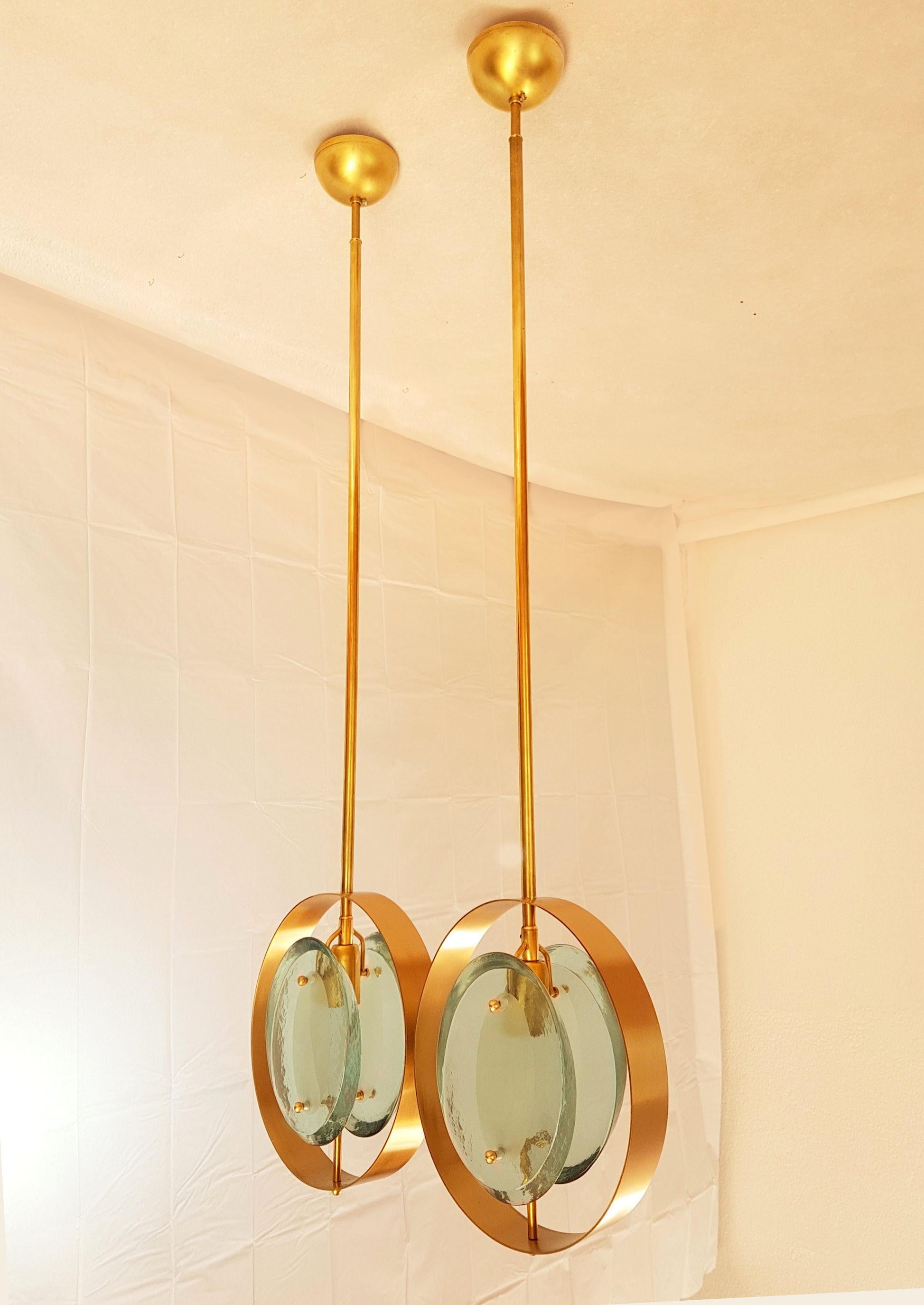 Pair of Mid-Century Modern, polished brass and green glass pendants, in the style of model 1933, by Max Ingrand for Fontana Arte, Italy, 1961.
They have 1 light each and have been rewired for the US.
The height of the stem can be changed.
Size: