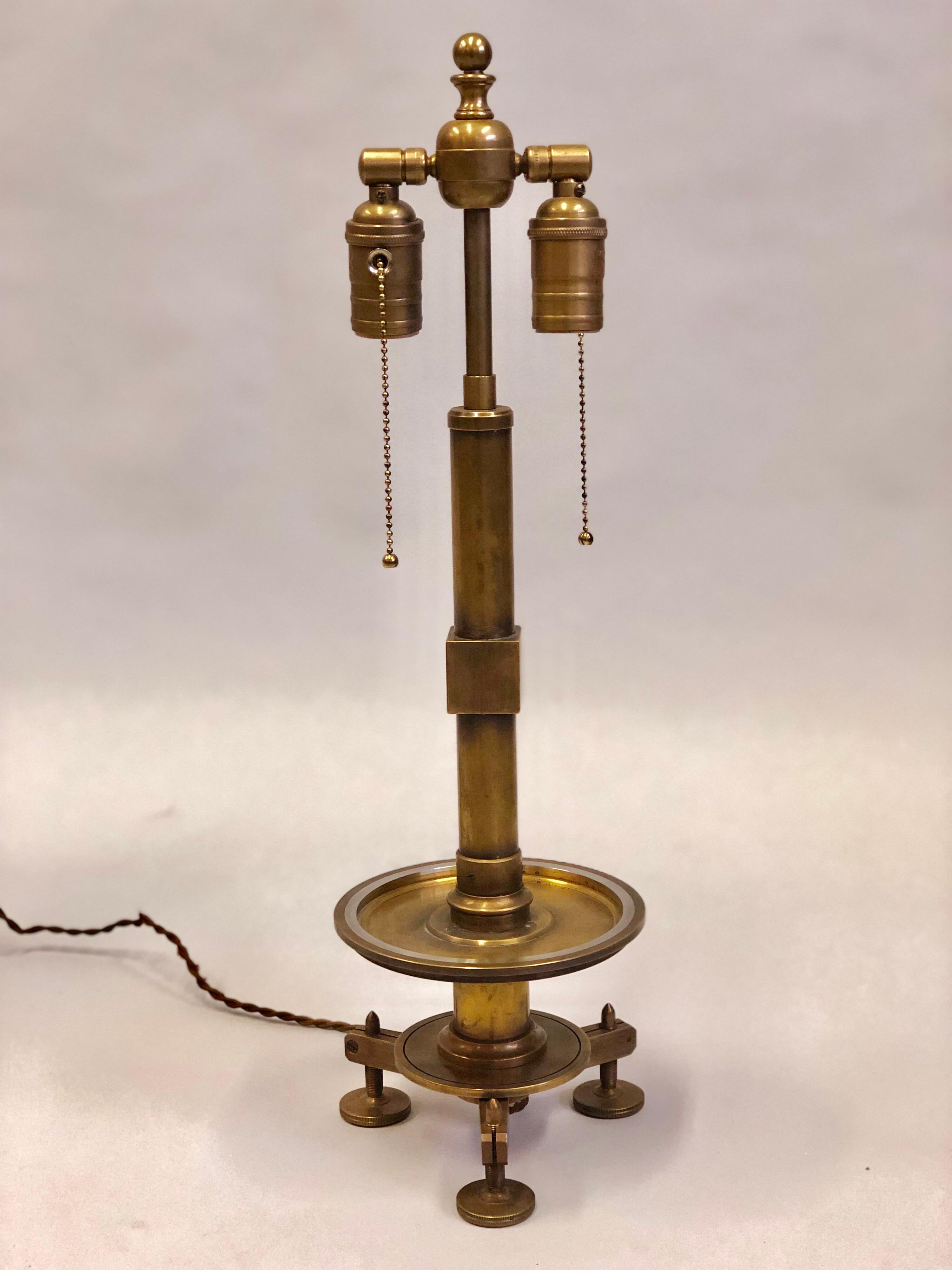 Elegant pair of French Modern Neoclassical brass and steel industrial style table lamps. The lamps are elegantly conceived within the framework of chic modern neoclassical forms but actualized with brass and steel industrial detailing to achieve a.