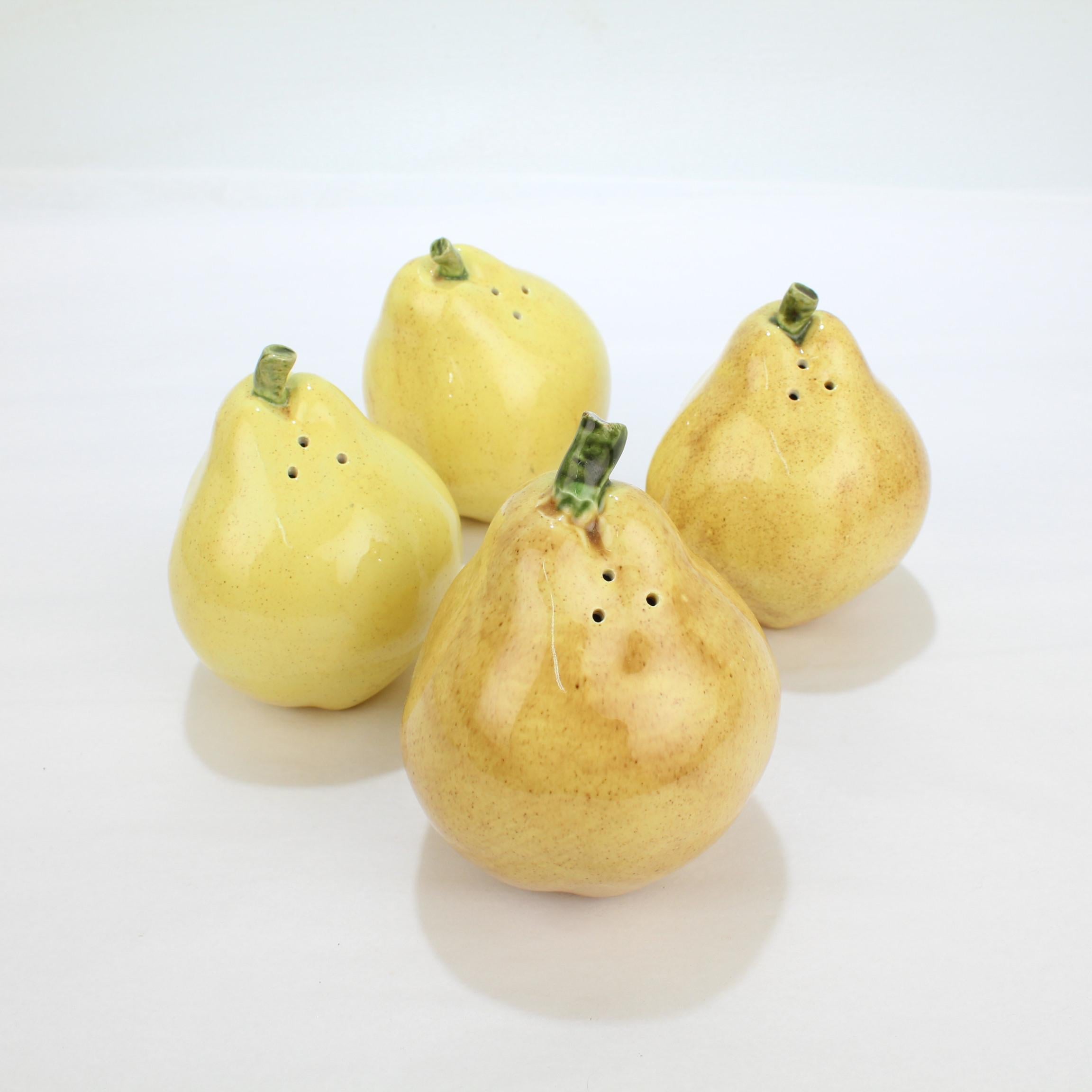 A group of four figural pottery pear shaped salt and pepper shakers.

In the form of yellow pears with twig stems.

Perfect for a bountiful table!

Marked to the bases with a partial incised P and J mark.

Measures:
Height each ca. 4