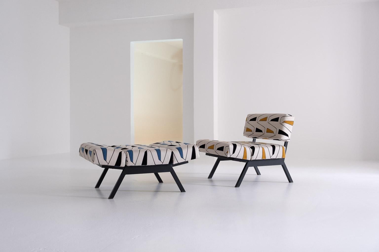 2 two ‚panchetto' reclining chairs by rito valla for ip. the paddings are expertly reupholstered (including handstitching) in two different colour sets of the extremely elegant ‚grafico‘ fabric, collection ‚alchimia‘, by french luxury brand
