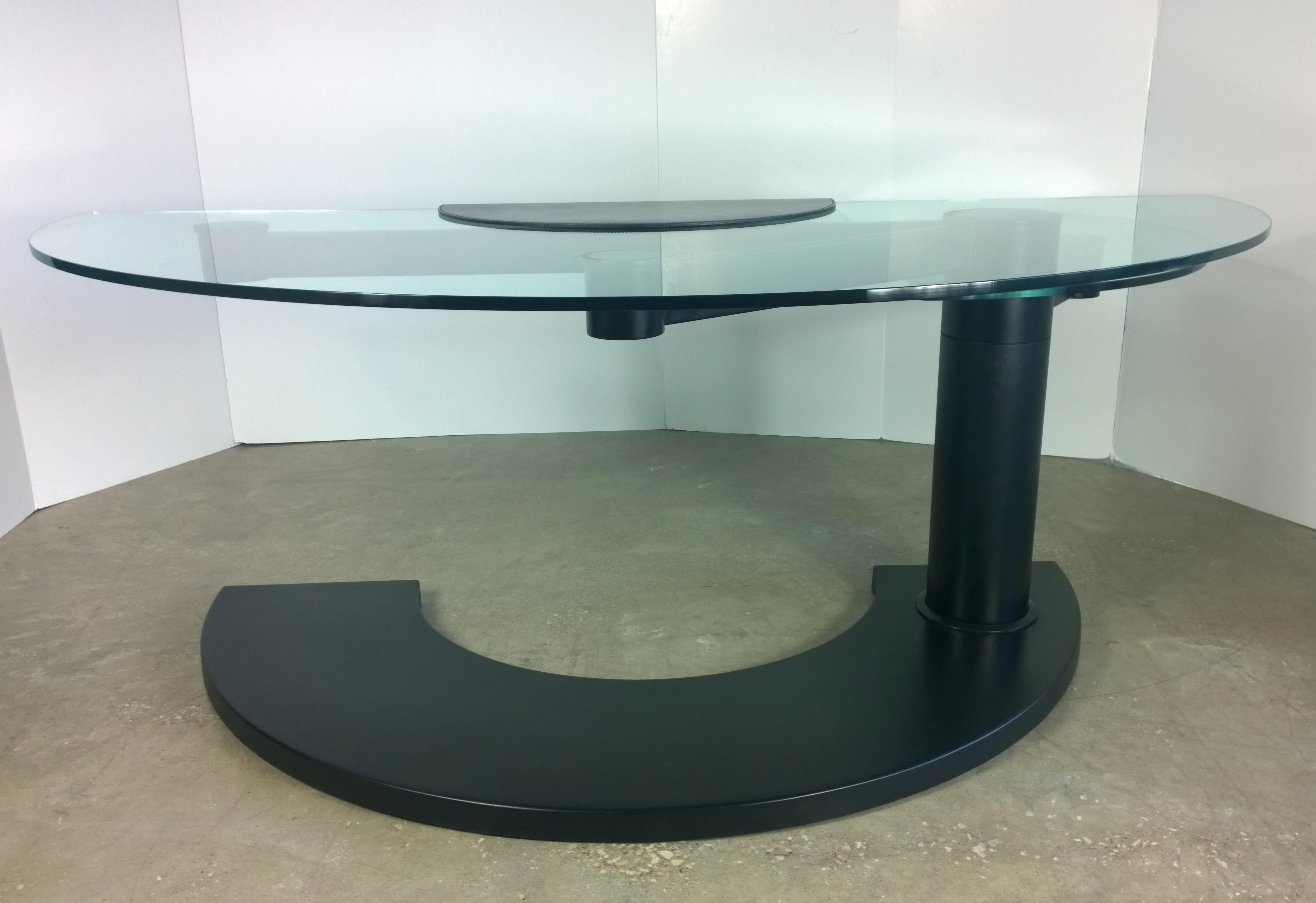 Offered is a very rare two-part glass top with black rubber over metal demilune base Arkitera desk 450 by Pierfranco Bagarotti for Pace. This quite rare Pace desk has a demilune shaped glass surface for the desktop and a second demilune shaped glass