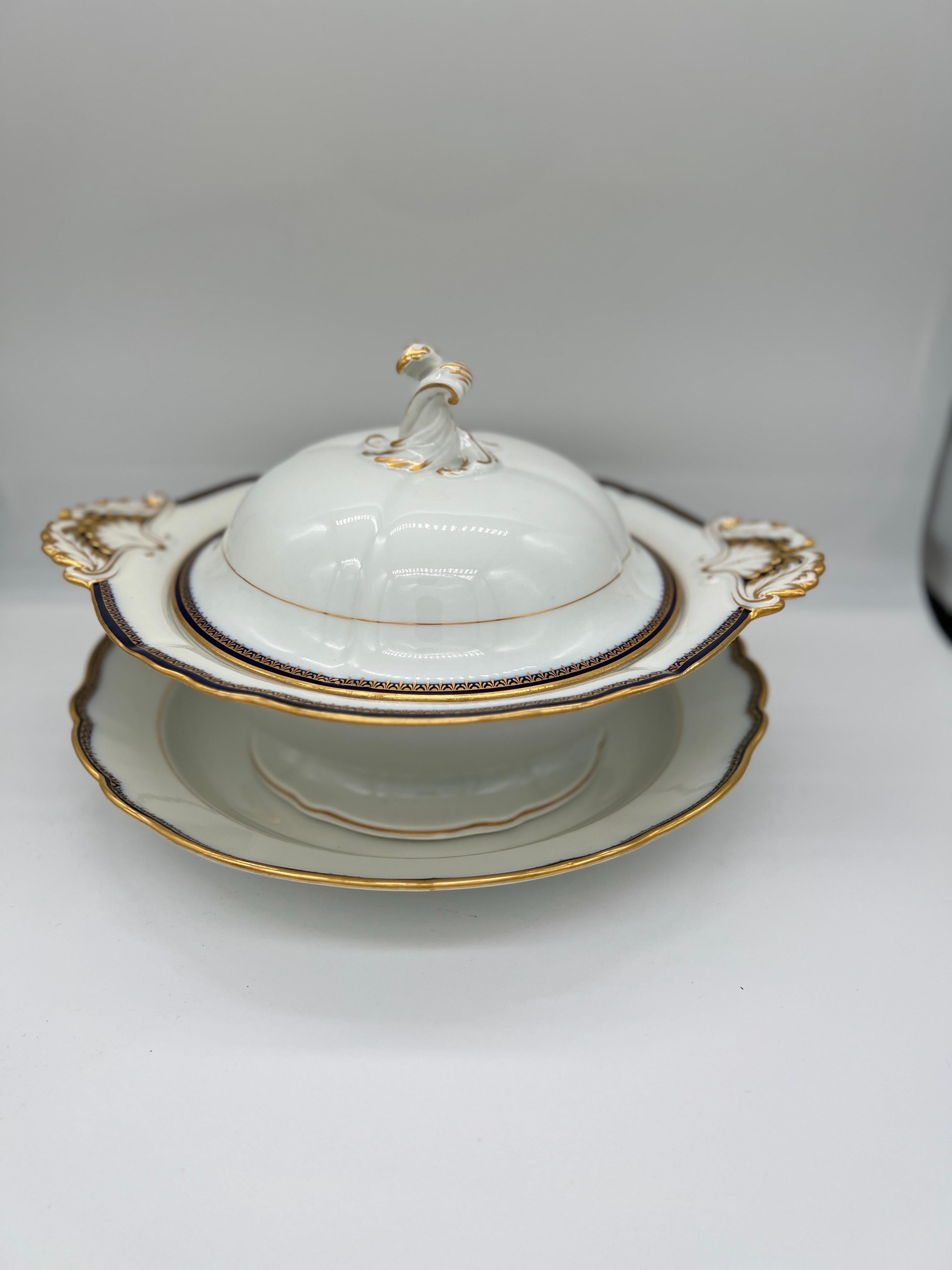 2 Pc, Meissen Porcelain Cobalt & Gold Rim Decorated Soup Tureen, Under Platter. 
The soup tureen is classic porcelain white and decorated to the rim and accents with cobalt and gilt overlay. The handles have a feathered shell form and a braided