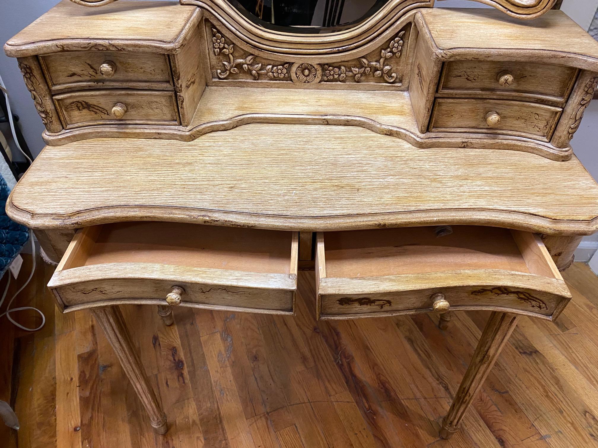 Vintage painted vanity with a 3 piece beveled mirror on top of a removable gallery with 4 small drawers for extra storage. There are 2 more drawers in the main area. You can also use this for a writing desk with or without the gallery and mirror.