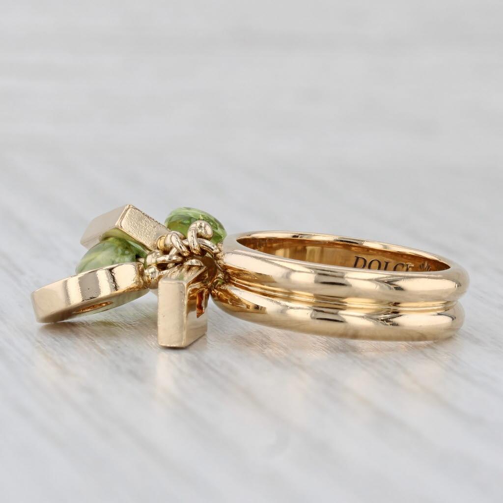 Gemstone Information:
- Natural Peridot -
Size - 7 x 5 mm each
Cut - Tumbled Oval
Color - Light Green

Metal: 18k Yellow Gold
Weight: 14 Grams 
Stamps: 750
Face Height: 15.5 mm 
Rise Above Finger: 6.5 mm
Band / Shank Width: 5.6 mm

This ring is a