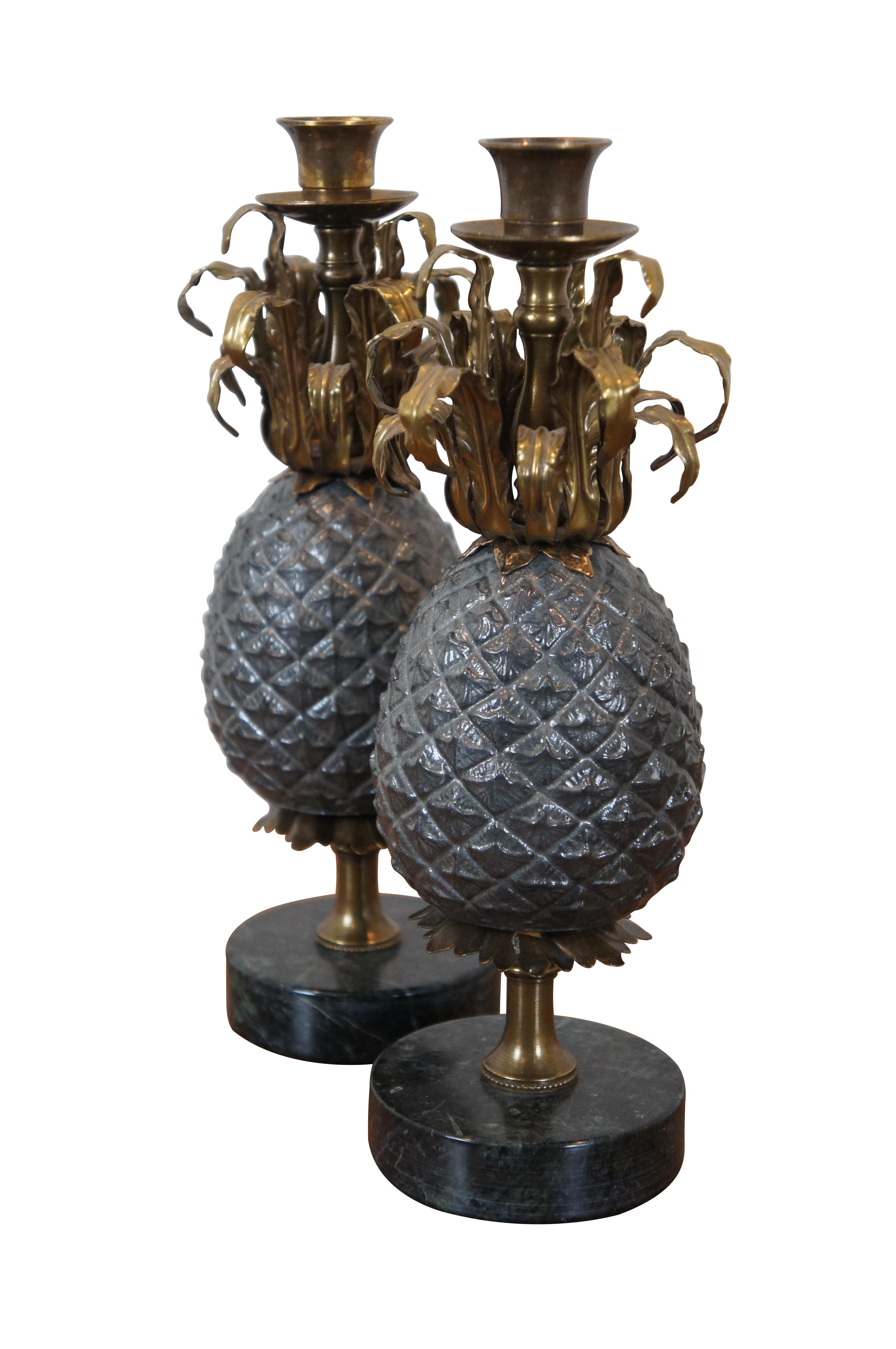 Pair of vintage candlesticks / taper candle holders by Petite Choses, purchased at Wakefield-Scearce Galleries of Shelbyvillle, Kentucky. Round black marble bases supporting pewter and brass pineapples, topped with traditionally styled candle cups.