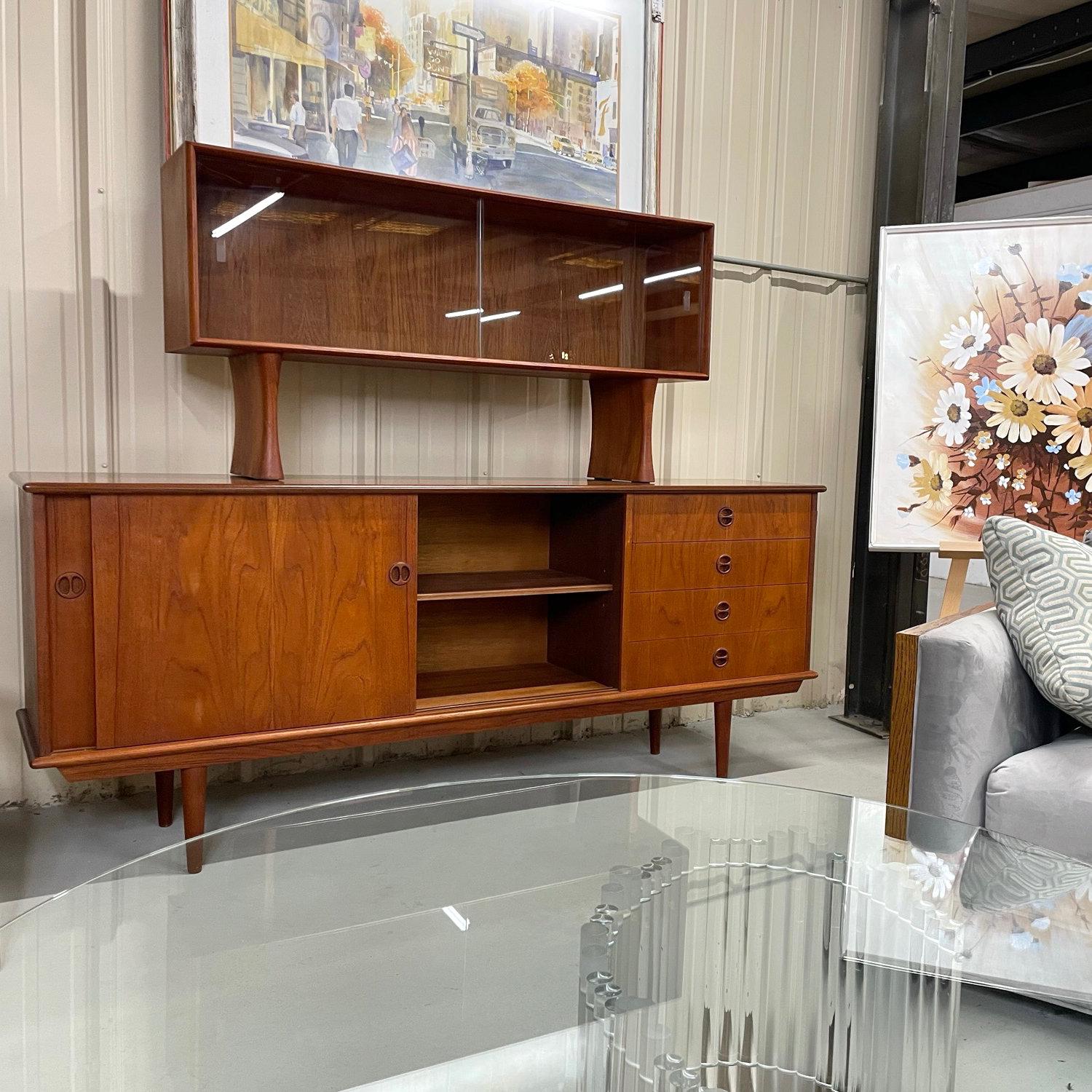 Early Danish teak Mid-Century Modern Danish tea credenza with china cabinet. Vintage 1950s/1960s, featuring graceful styling and craftsmanship throughout. The construction is exquisite, with virtually no warping or sagging after so many decades. You