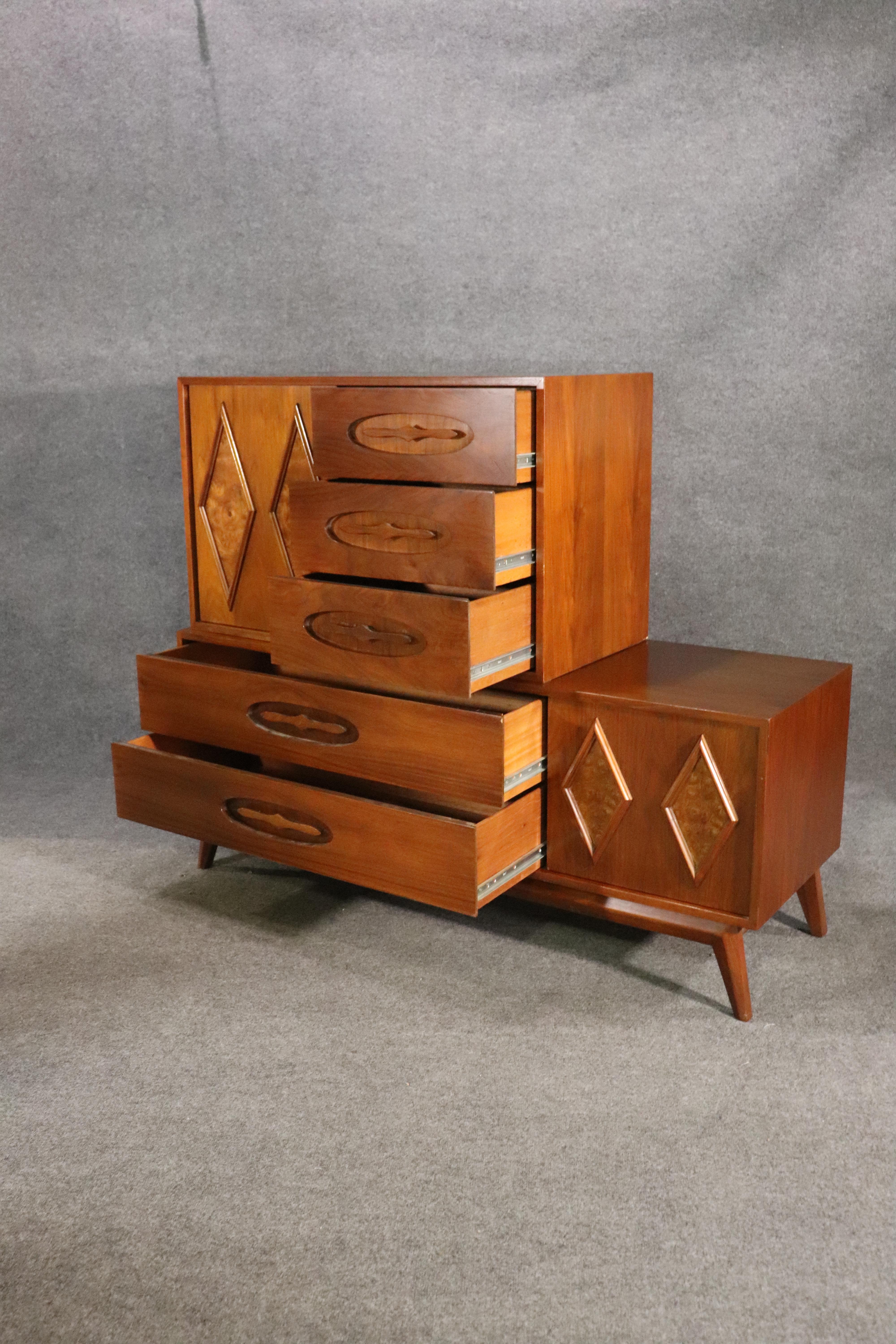 Mid-century modern dresser with sliding doors and ten total drawers. Unique design, featuring an off center top chest. Diamond figures of burl veneer give a handsome accent to the walnut grain.
Please confirm location NY or NJ