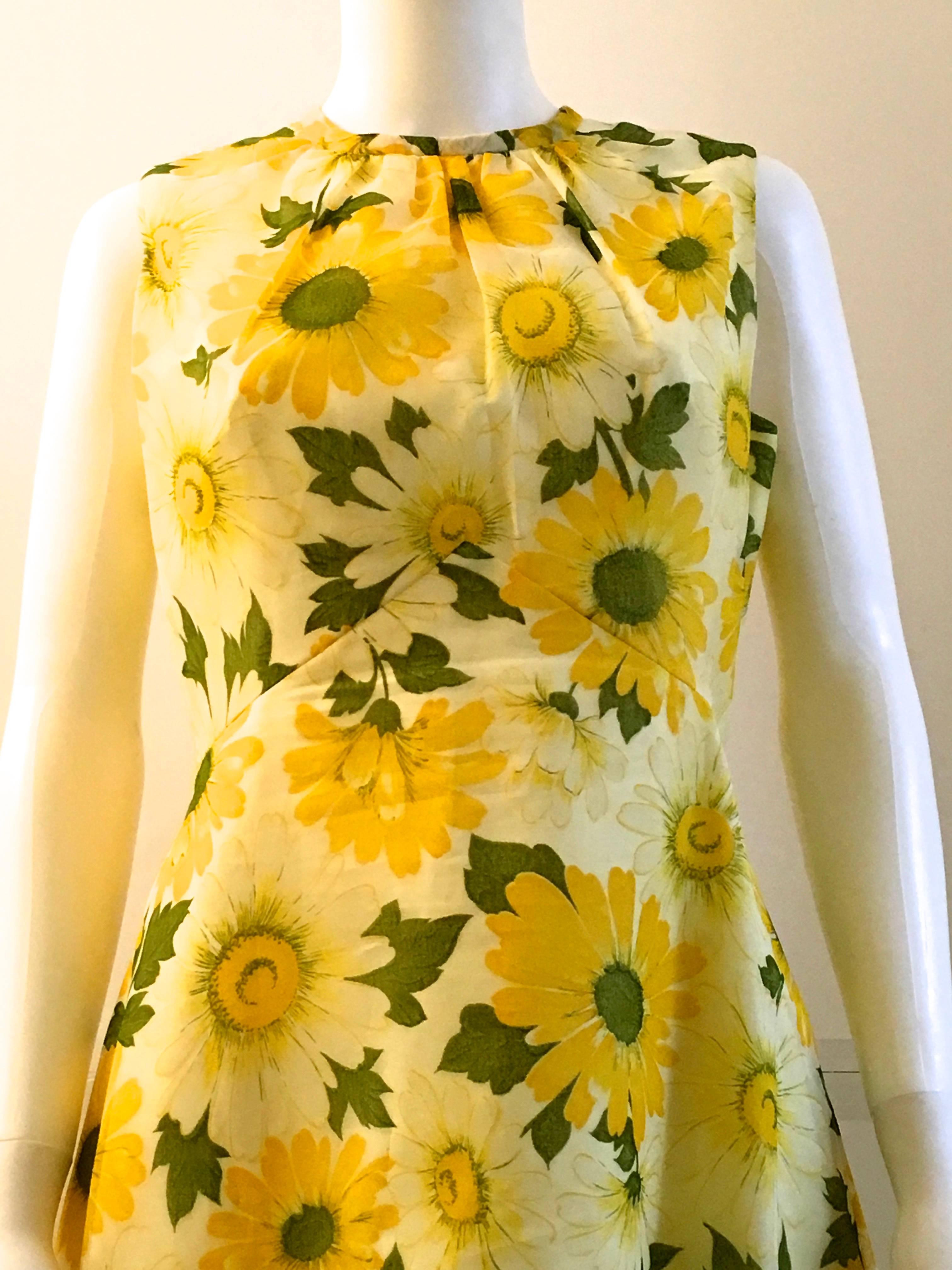 Presented here is a fabulous vintage two piece floral print set. This gorgeous dress and coat combination are both made from a lovely yellow flowered print fabric. The dress is from the 1970's and is extremely flattering when worn. The dress