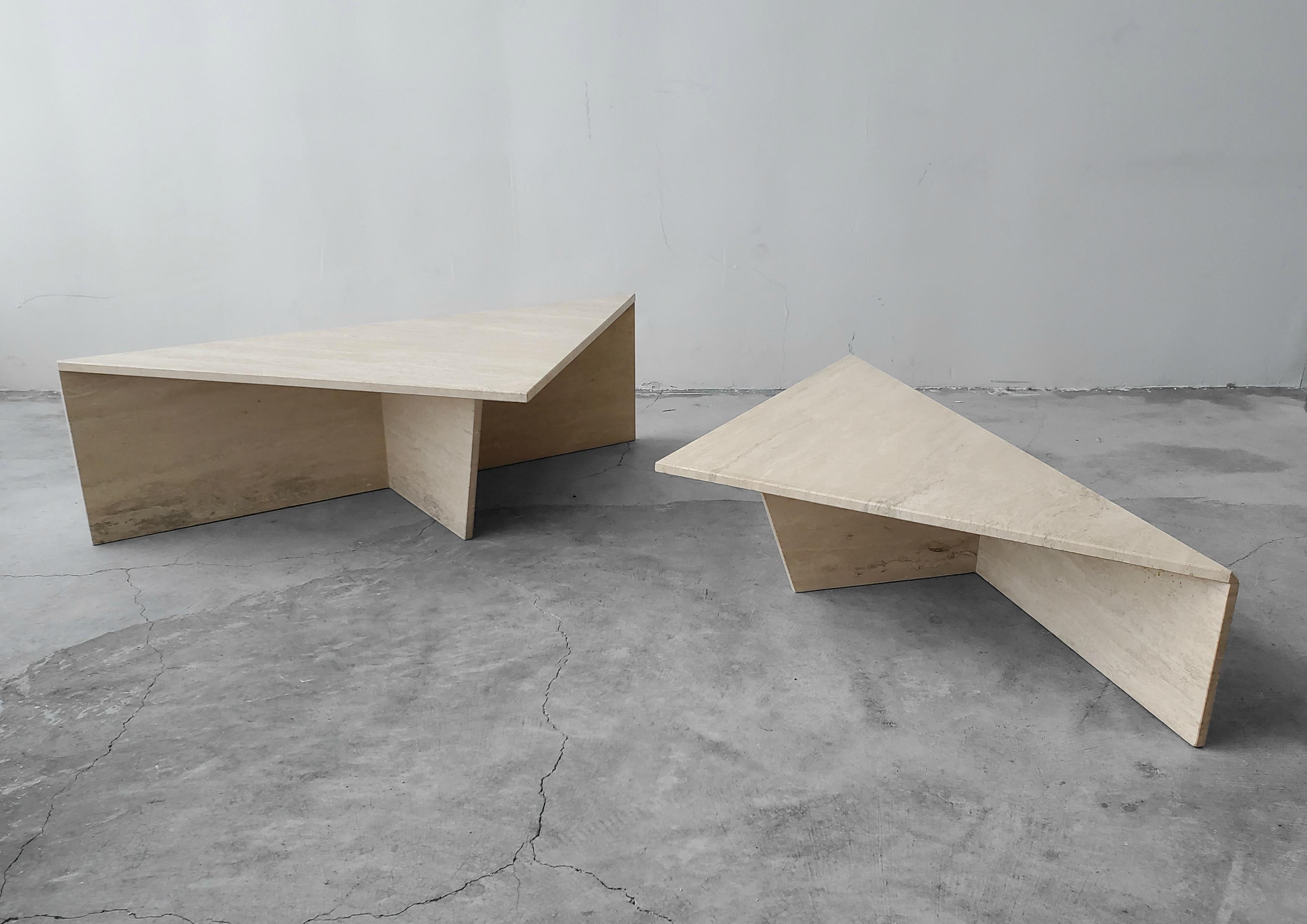 Classic Postmodern tiered Italian travertine coffee table. Simple beautiful piece. Table is of modernist and minimal design, comprised of 2 identical triangular tables of different heights, they can be arranged in any manner to form a square, a