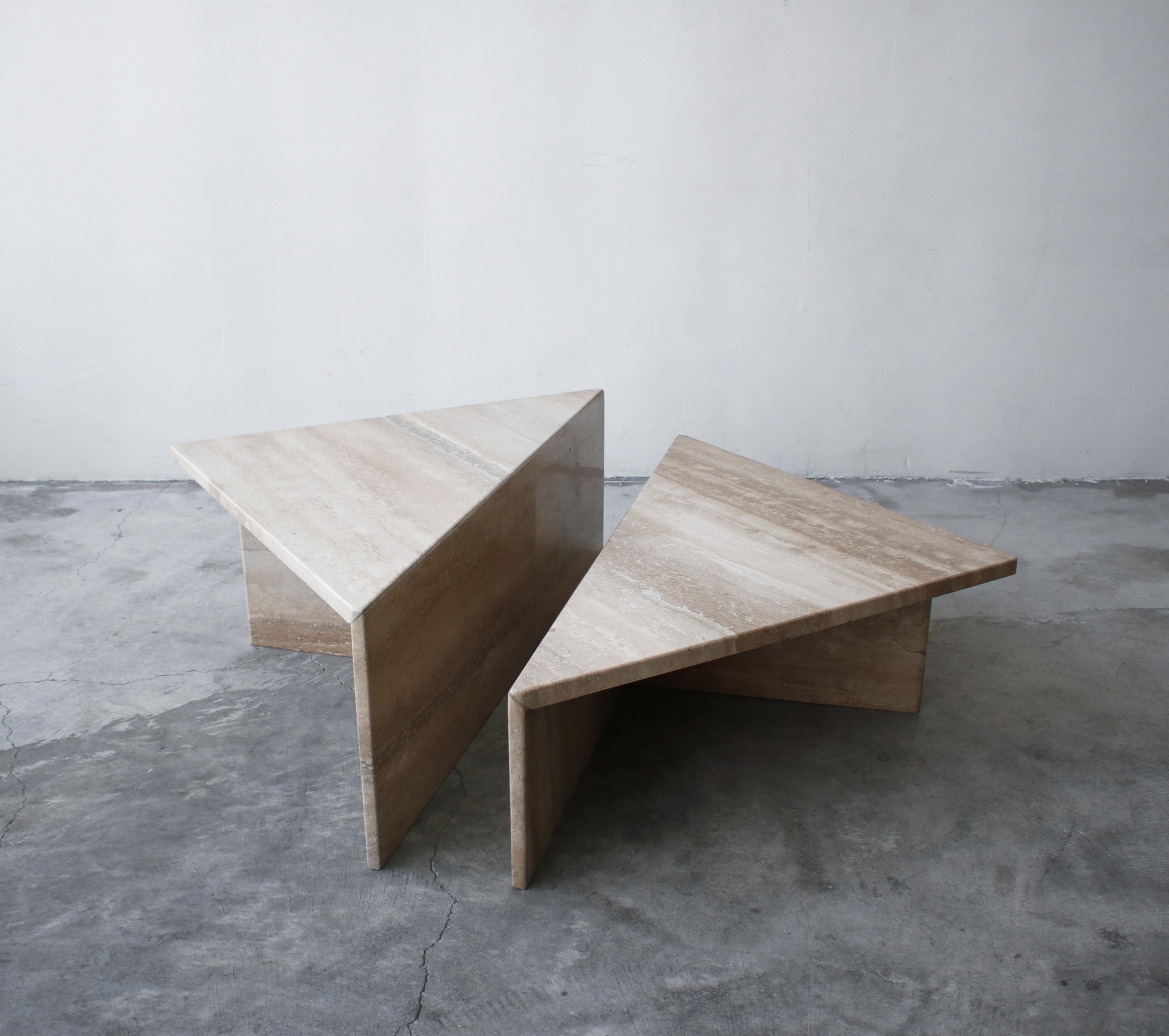 Classic Postmodern tiered Italian travertine coffee table. Simple beautiful piece. Table is of modernist and minimal design, comprised of 2 triangular tables of different heights, they can be configured in any manner to form a square or a rectangle,