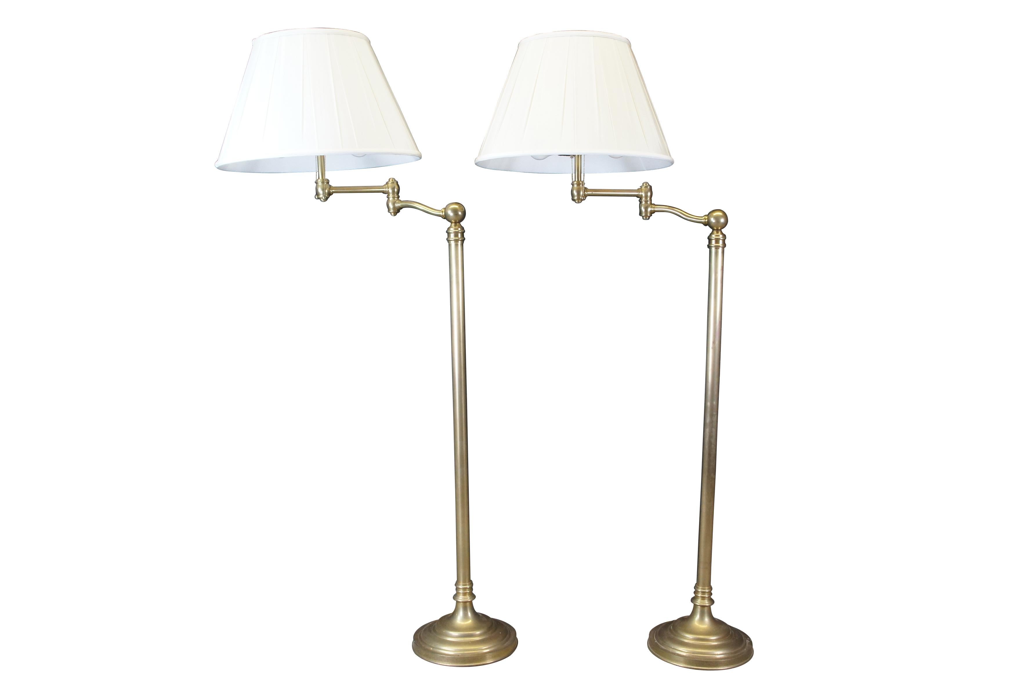 2 Visual Comfort Sargent Swing Arm Floor Lamp, Designed by Ralph Lauren.  Features Natural Antiqued Brass with Silk Shades.  The lamp has two lights both with their own pull switch.

Dimensions:
64