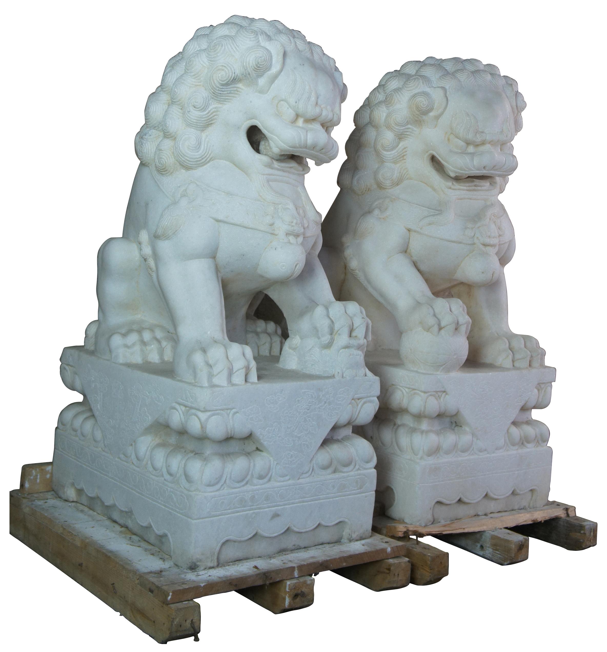 Two monumental antique Chines Chinese foo dogs, circa last quarter 19th century. Made of white marble featuring meticulously carved detail.

Provenance; Private Collection where acquired by the previous owner from an important New York estate in