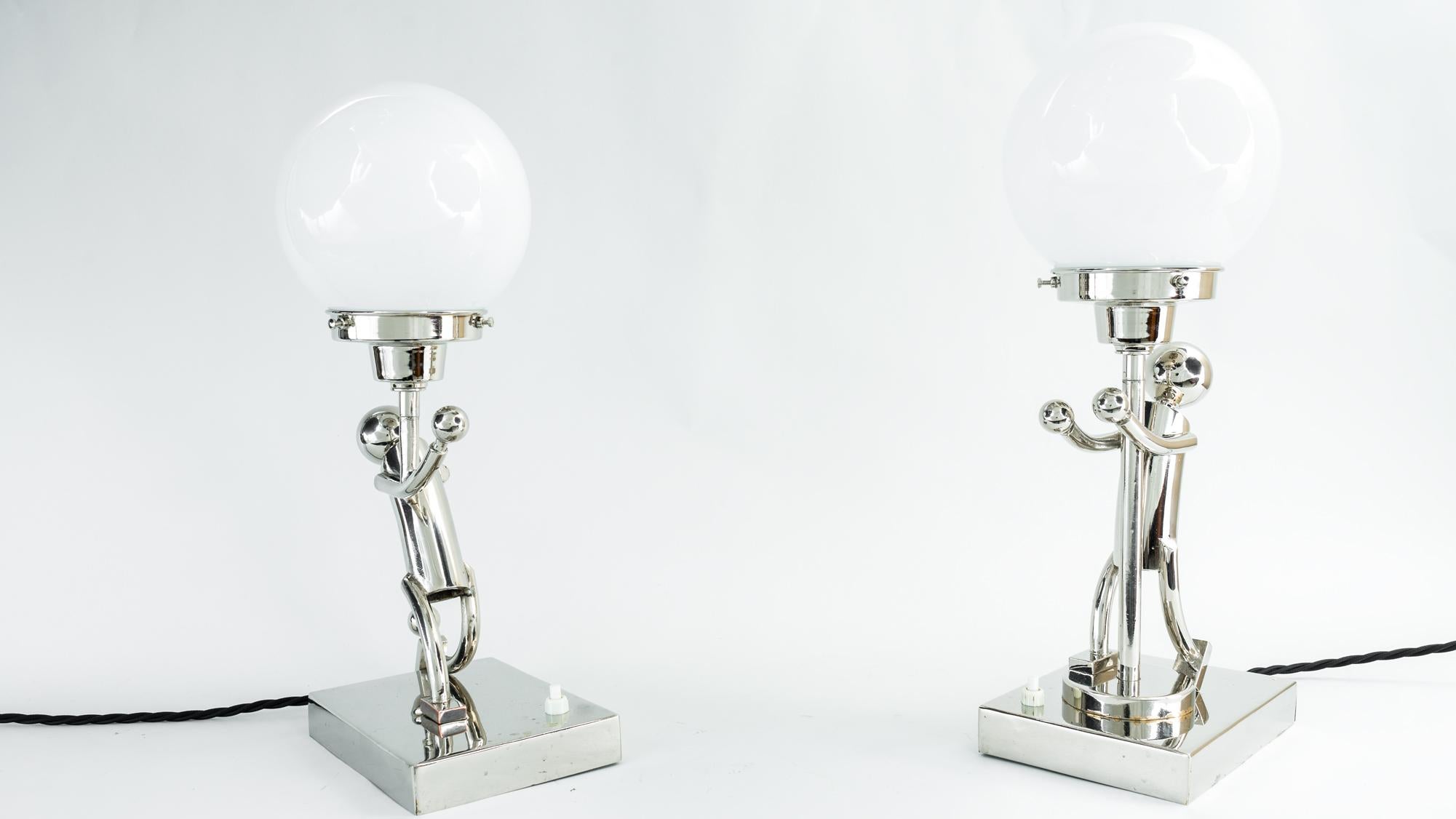 2 rare table lamps in style of Hagenauer, Vienna, circa 1920s
Brass nickel-plated
Original condition
Opal glass shades.