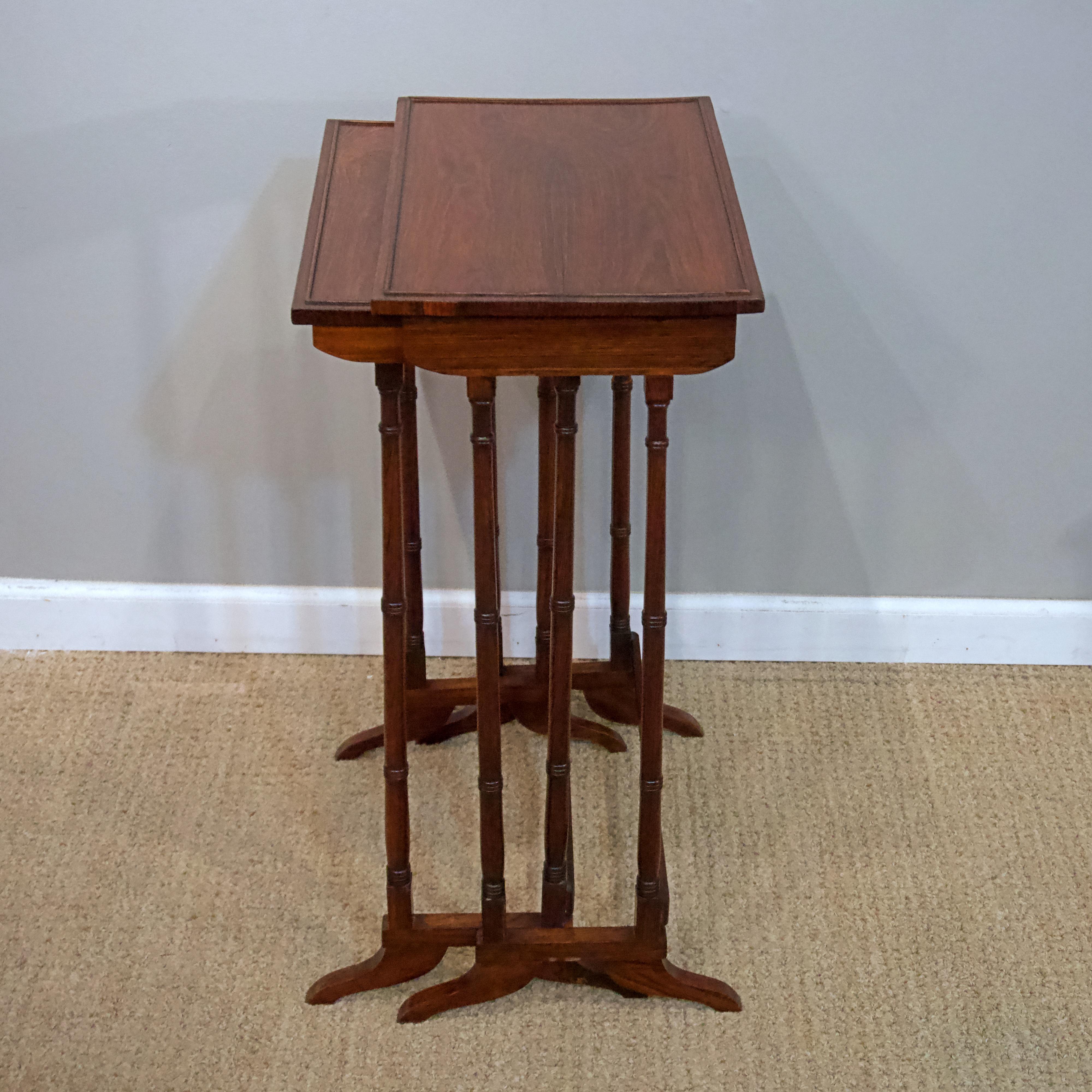 Comprised of two rosewood nesting tables.