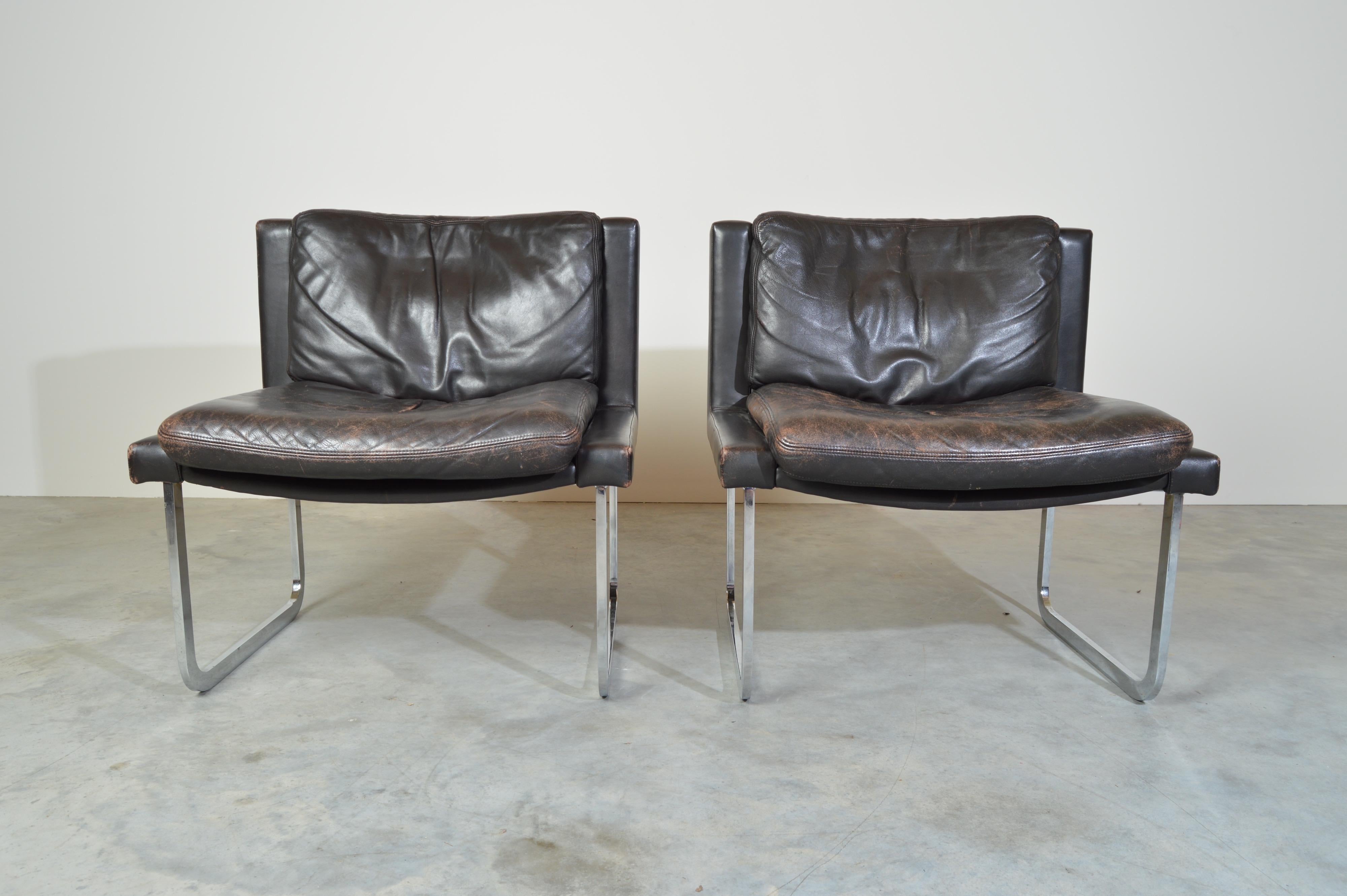 A pair of original Robert Haussmann cantilever chairs in leather and chrome. 
Beautiful patina to the leather. Solid and in great condition throughout. Typical signs of use to the leather. Nothing major.