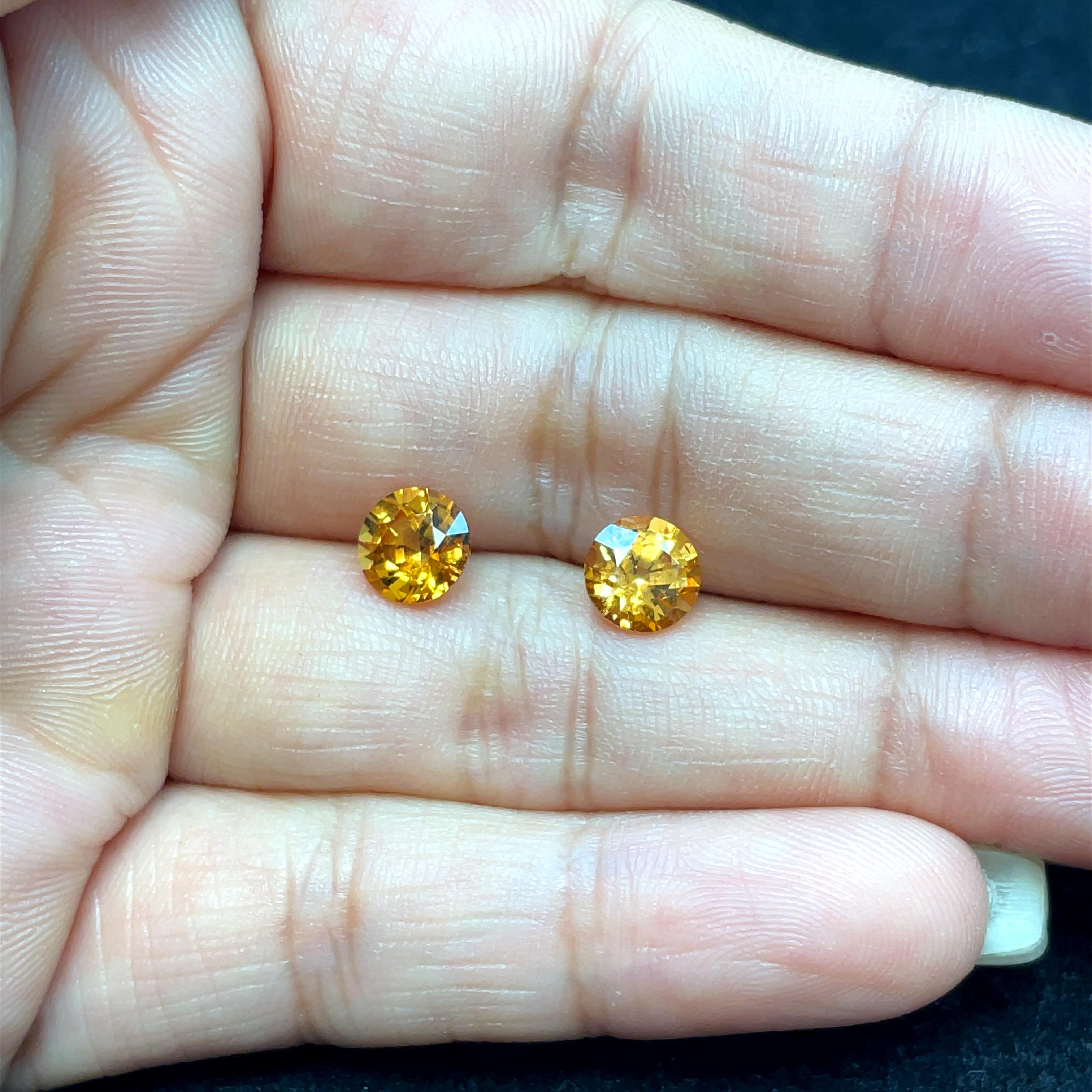 The striking orange color of these beautiful stones is sure to catch attention and make an impression. 

With one gem weighing 1.63 carats and measuring 6.81 x 6.78 x 4.51 mm, and the other weighing 1.65 carats and measuring 6.80 x 6.83 x 4.62 mm,