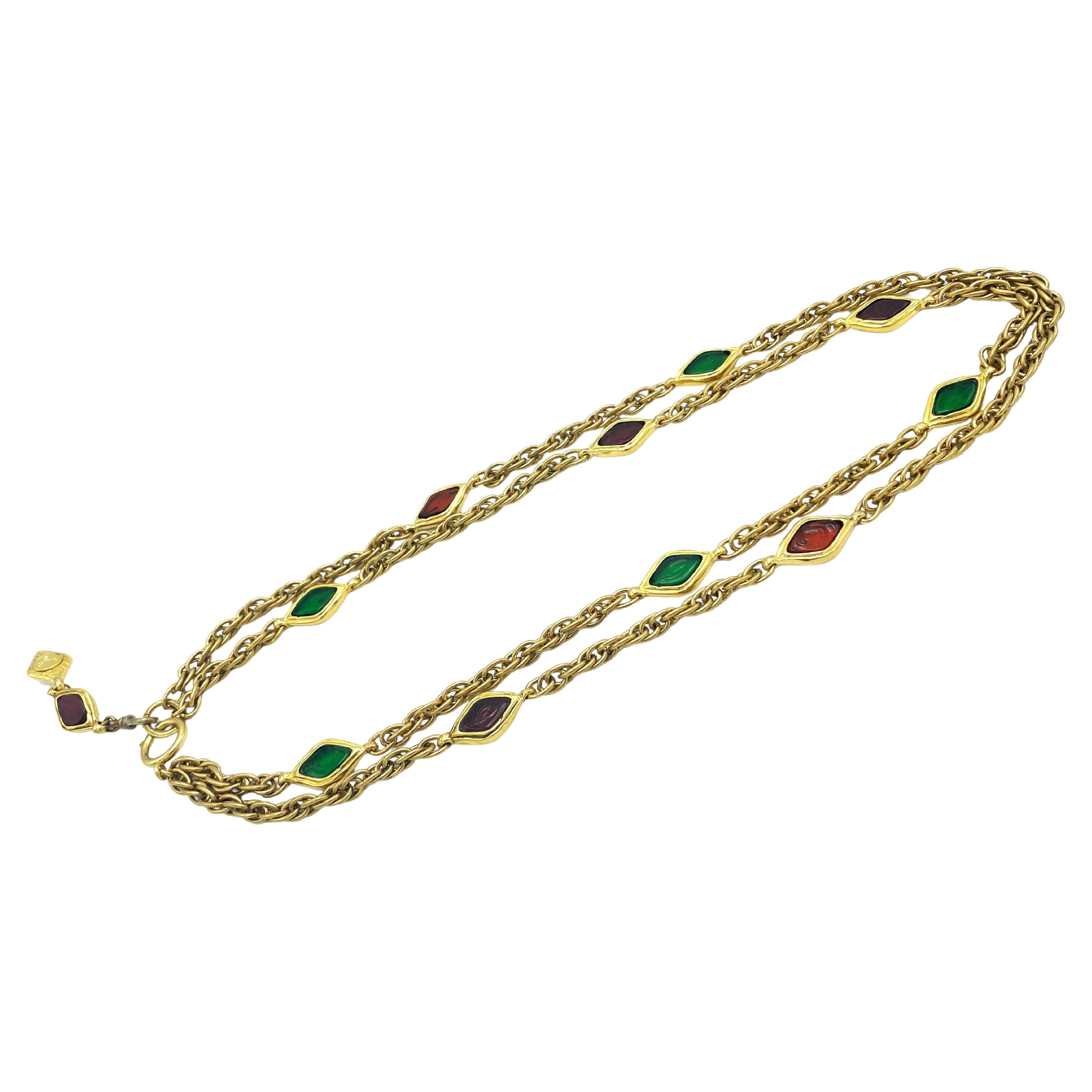 
 Chanel Gripoix necklace by K. Lagerfeld (Made in France) 2 row gold-plated chain with 11 red and green pate de verre. Signed on the quilted tag on the clasp . Late 1970's early 1980 
Aditional Information:
Dimension:  Length from the watch clasp