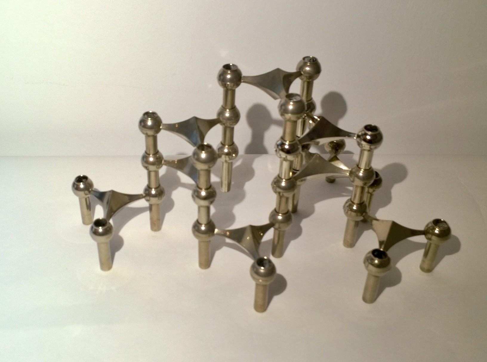 Offered are two sets of nine Mid-Century Modern Caesar Stoffi for Fritz Nagel matte chrome candle holders. Quite architectural in design and versatile in configuration. Fun to put together in different shapes heights and widths.