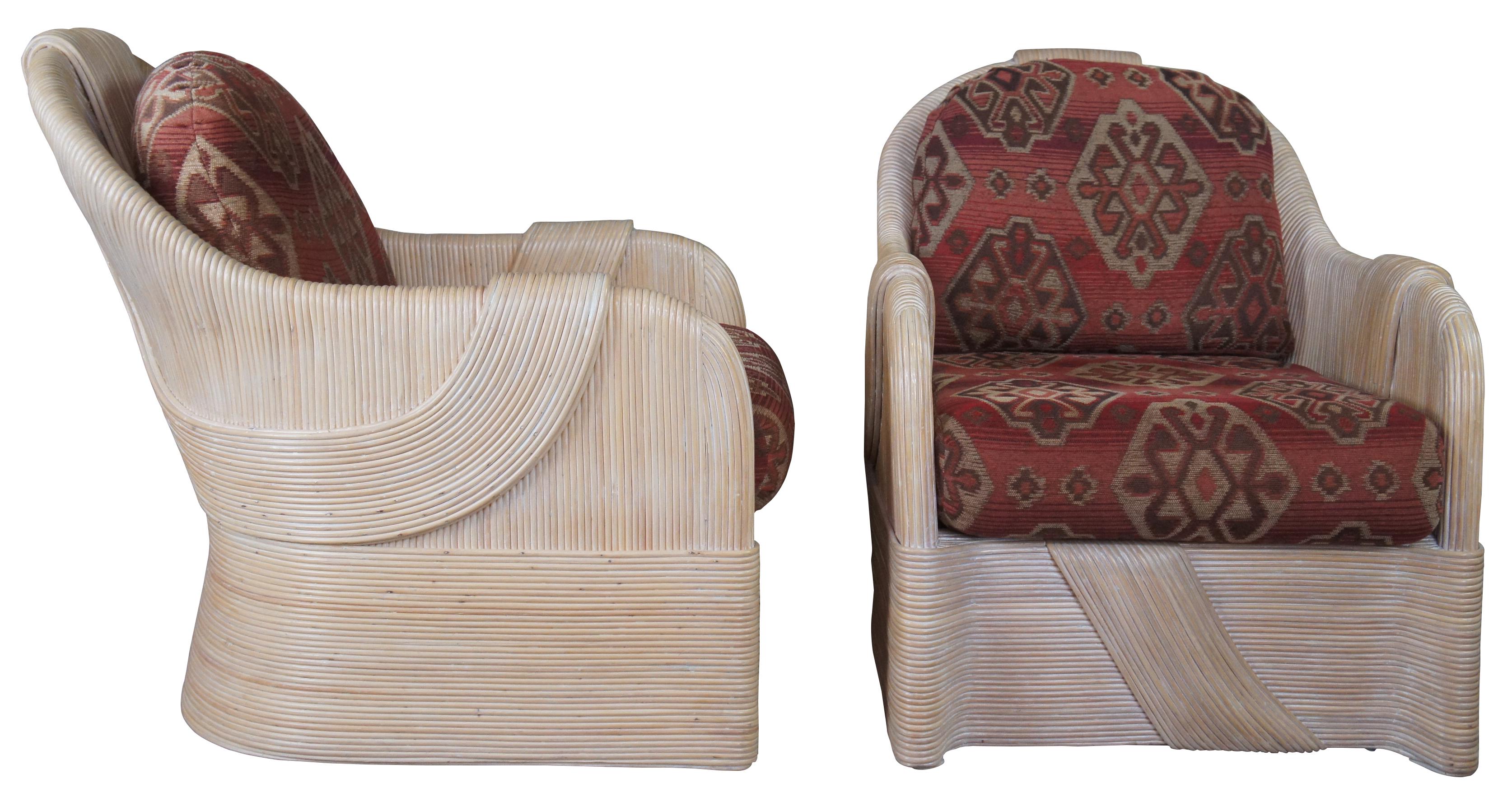Sculptural pair of split or pencil reed club chairs. Features a red southwestern fabric.
  
