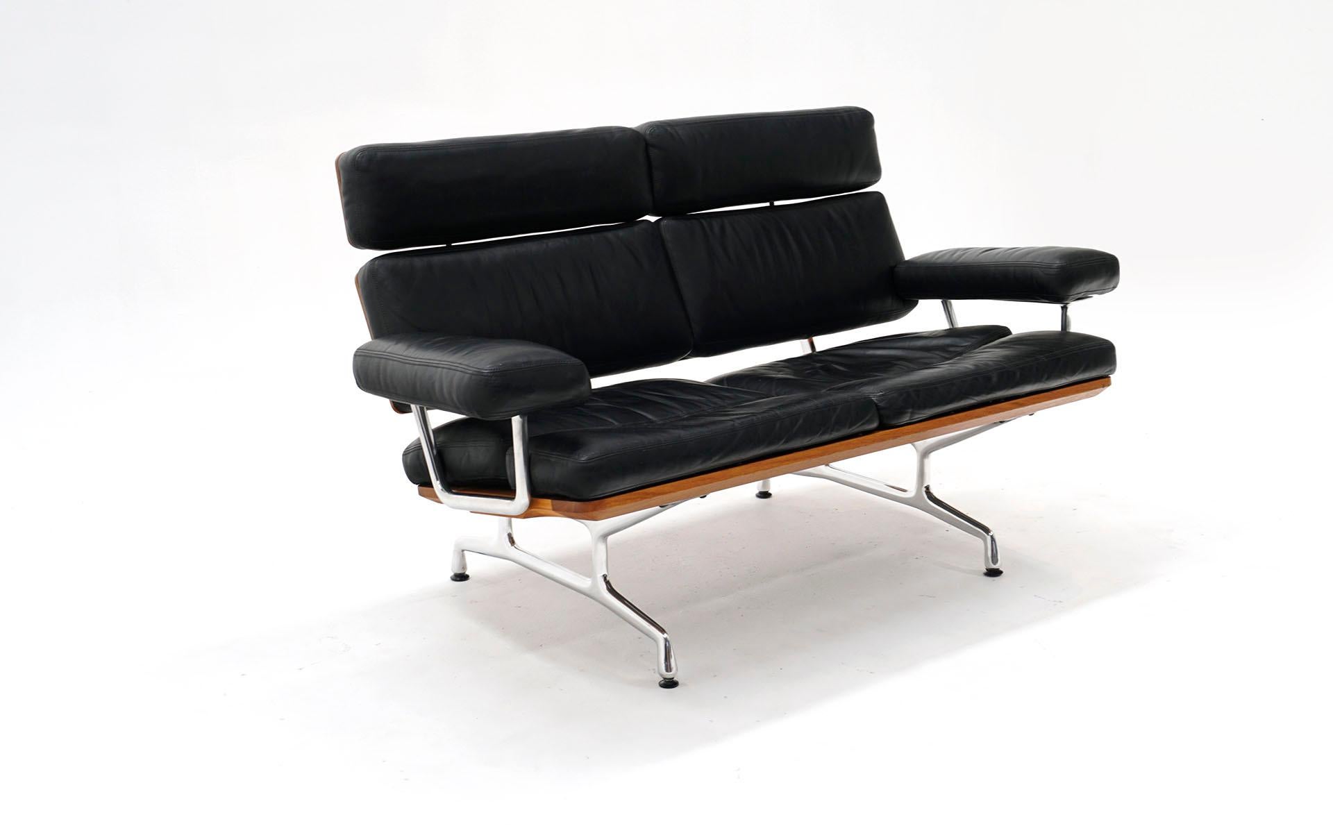 Eames two seat sofa loveseat for Herman Miller. Early production. Black Leather and solid walnut. The Eames sofa is the last piece of furniture produced by the Eames Office, which completed the design after Charles Eames died in 1978. It went into