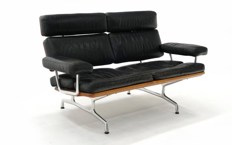 Eames two seat sofa loveseat / love seat for Herman Miller. Early production. Black Leather and solid teak. The Eames sofa is the last piece of furniture produced by the Eames Office, which completed the design after Charles Eames died in 1978. It