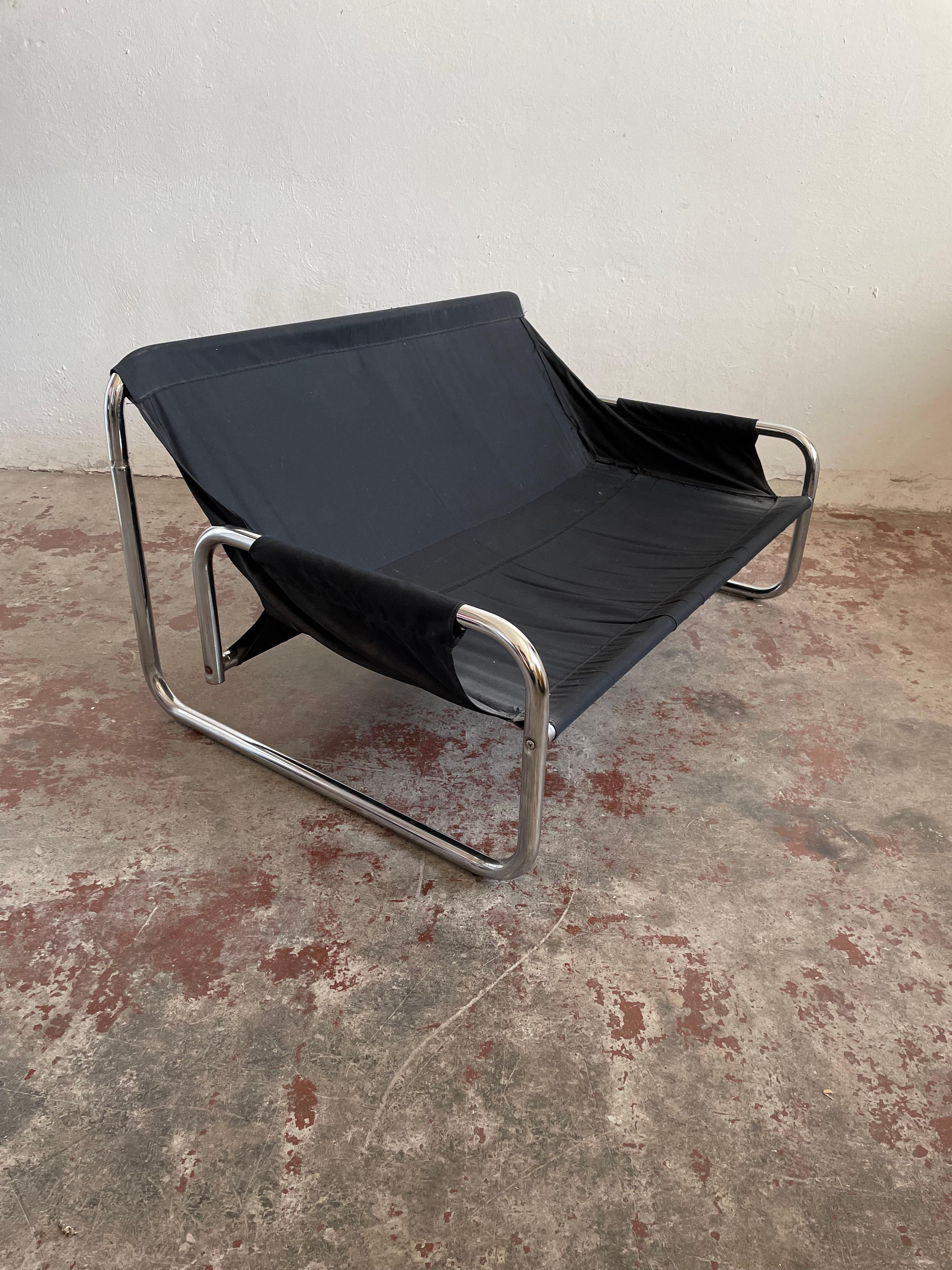 Exceptionally comfortable 2-seater lounge sofa/love-seat manufactured in the 1970s by Swed Form

Design by Johan Bertil Häggström

The chair features a Bauhaus-style tubular chrome frame with a seat made of black canvas. The chair has an