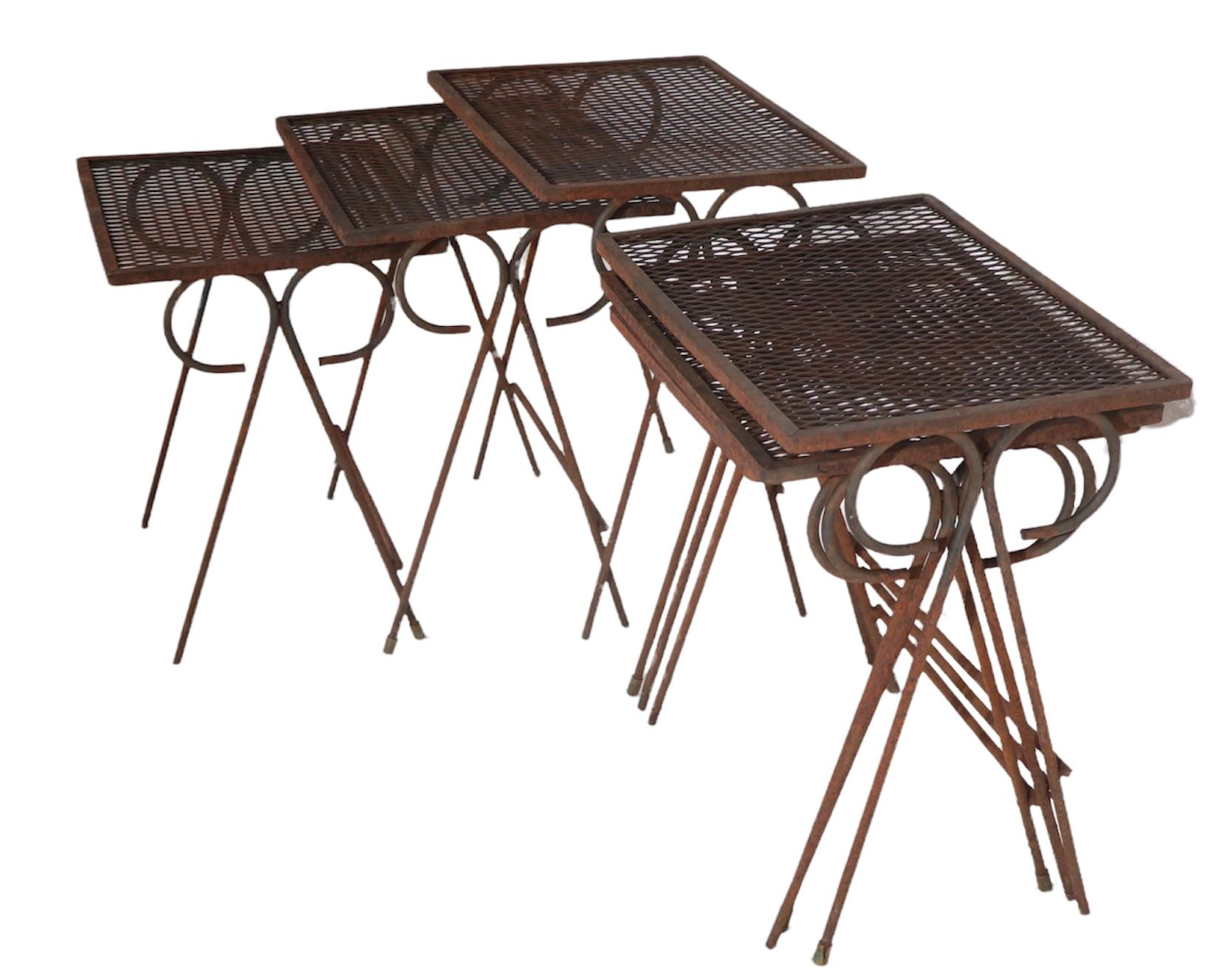 Matched sets of three graduated nesting tables of wrought iron, and metal mesh, designed by Maurizio Tempestini, for Salterini. The tables are all structurally sound and sturdy, some may be missing rubber pad feet, and all show surface rust. Usable