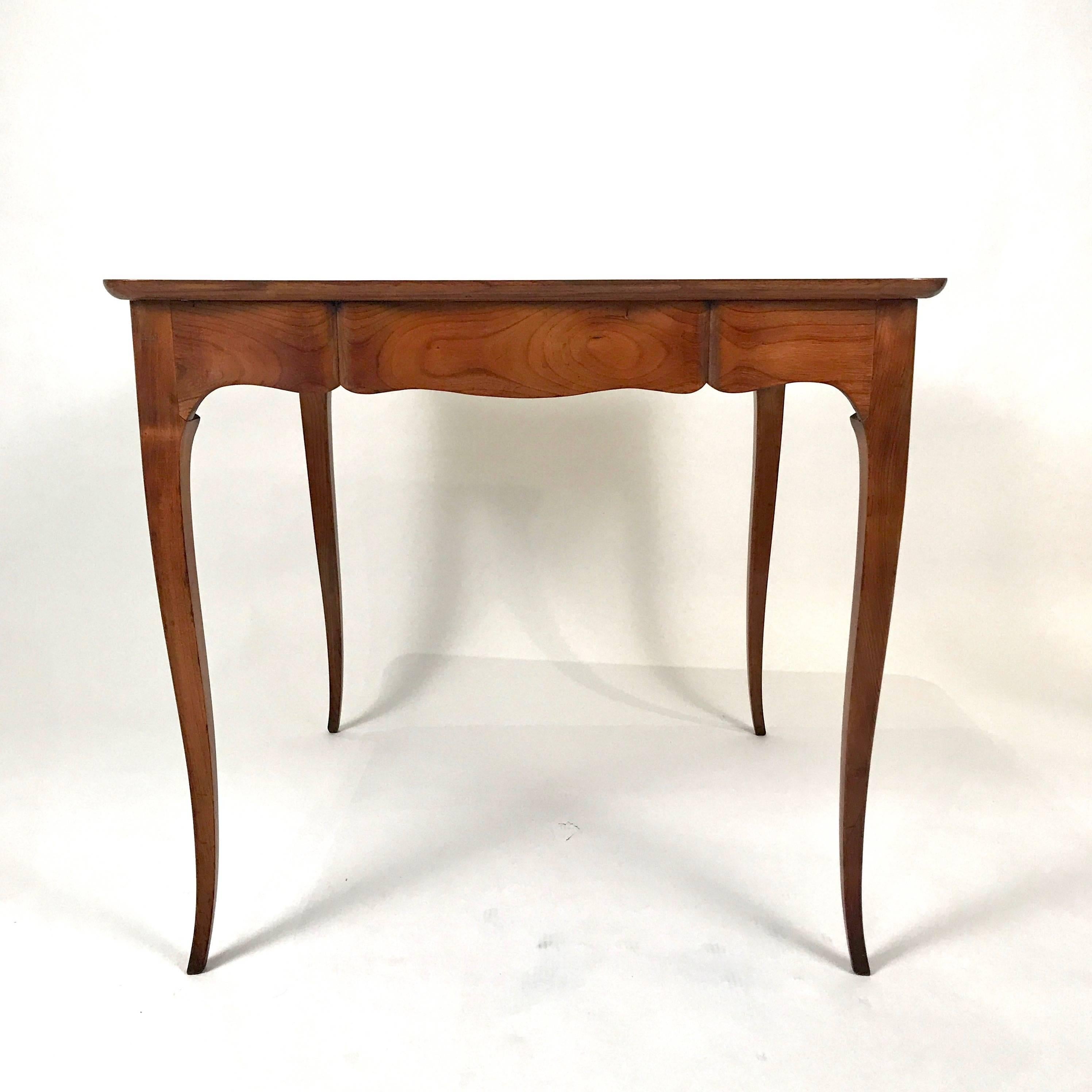 Important two-sided writing desk or game table dating from sometime between 1938-1953. This stunning piece is from Carlhian Paris, France and is constructed with two or more different types of fruitwood. Visibly handcrafted by a master. Hand-carved