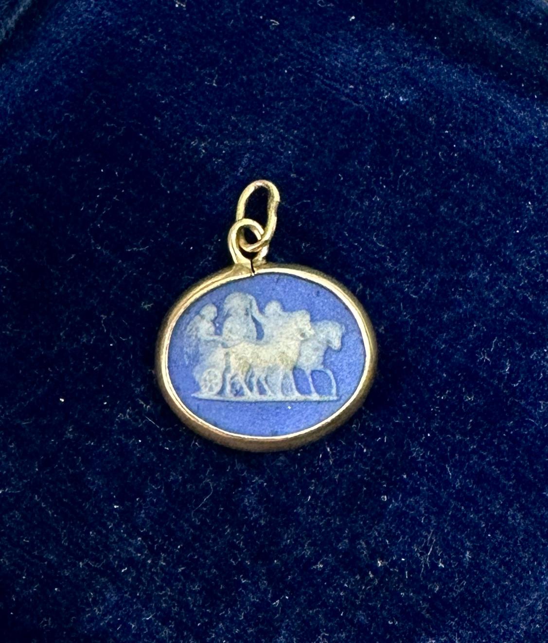 Indulge in a stunning antique Victorian Blue Jasper Cameo Pendant with an image of Gods with a horse drawn chariot on one side and a God or man running with a fabulous deer on the other side and set in 10 Karat gold.
The antique cameo pendant is