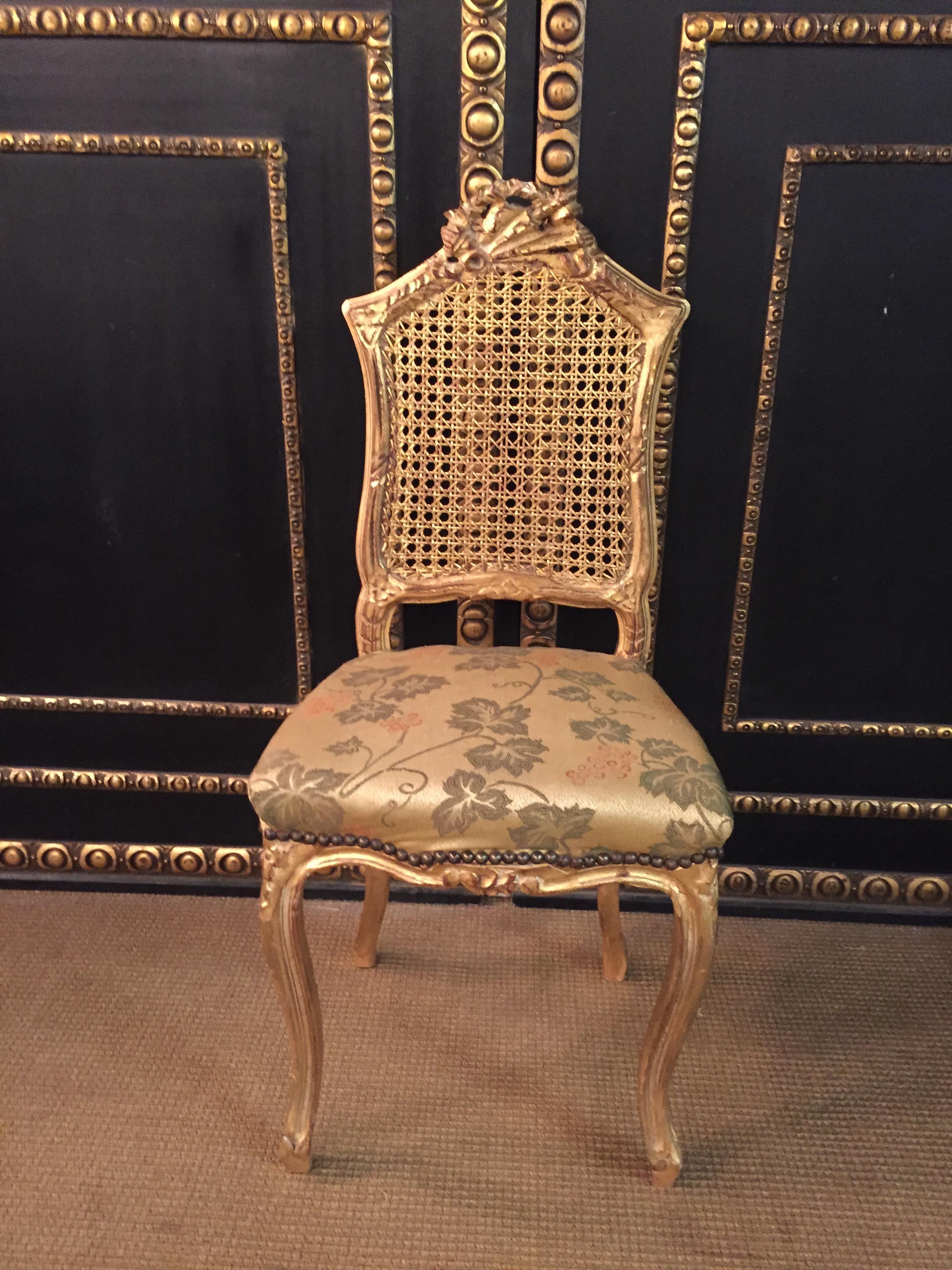 Solid wood, frame completely gilded. Upholstered seat and covered with a satin fabric.
 