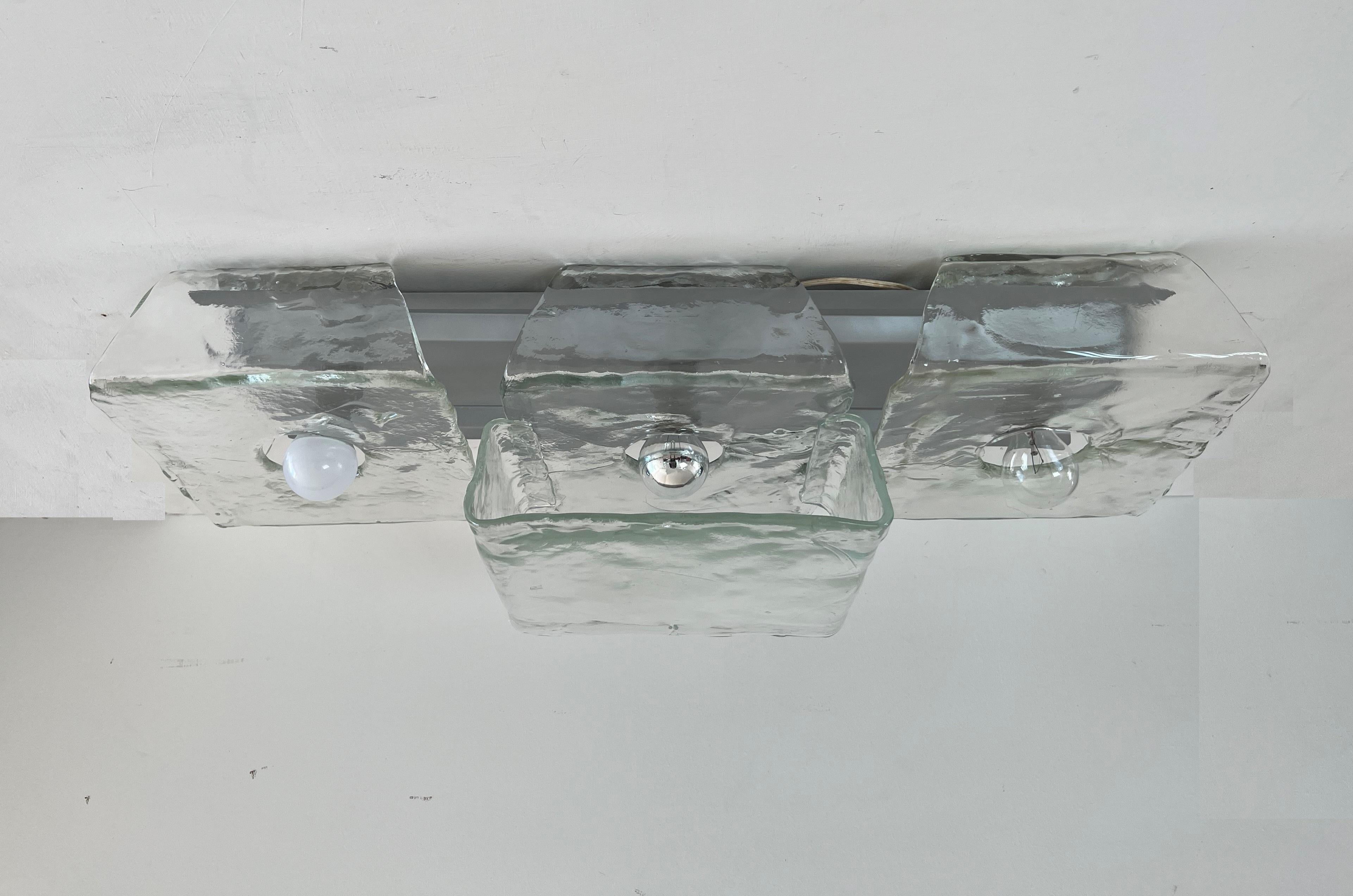 Two Mid-Century Modern flushmounts lamp by Mazzega, most likely designed by Carlo Nason, circa 1970, consisting on 4 clear murano glass pieces that slide into a grey/silver lacquered base ( this can be changed to white or any desired color to math