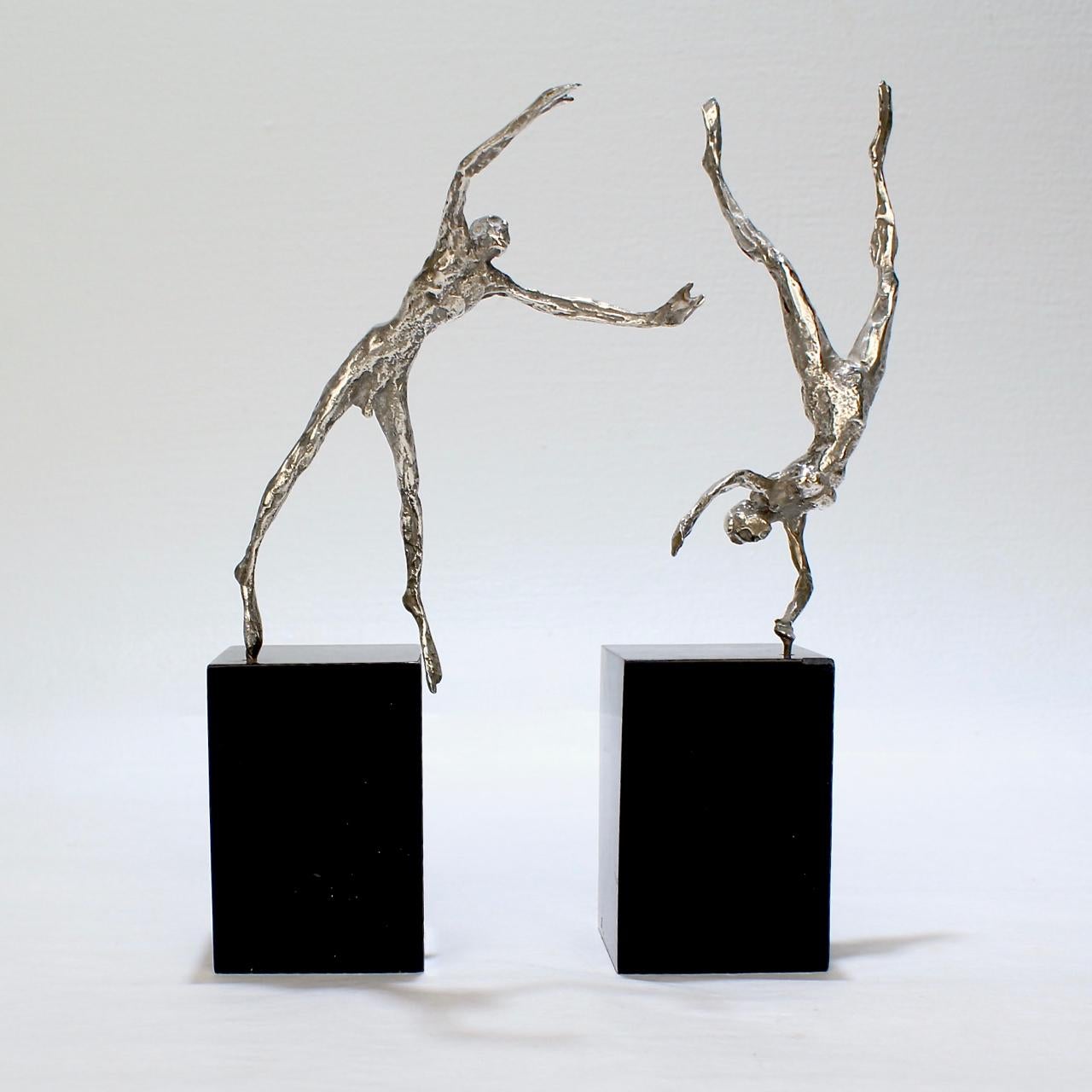 A very fine pair of cabinet-sized silver figurines by Stanley Bleifeld.

Modeled as Adam and Eve falling from the Grace of Eden.

Mounted with pins on black marble plinths. The figures can spin in their mounts and can be positioned in varying